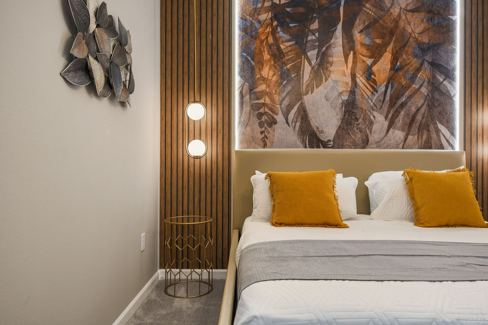 Warm bedroom with nature-inspired decor, modern lighting, and cozy accents.