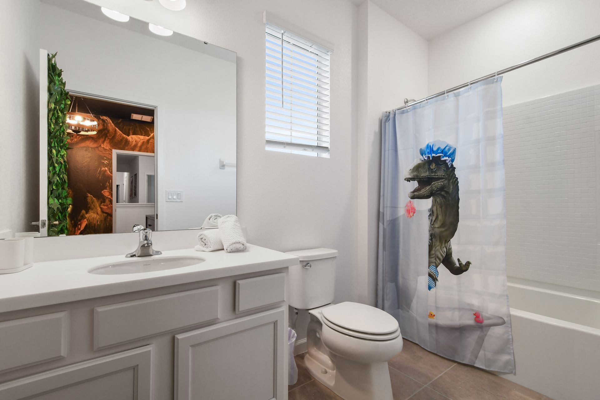 Bright and clean bathroom with a large mirror and a full shower-tub combo.