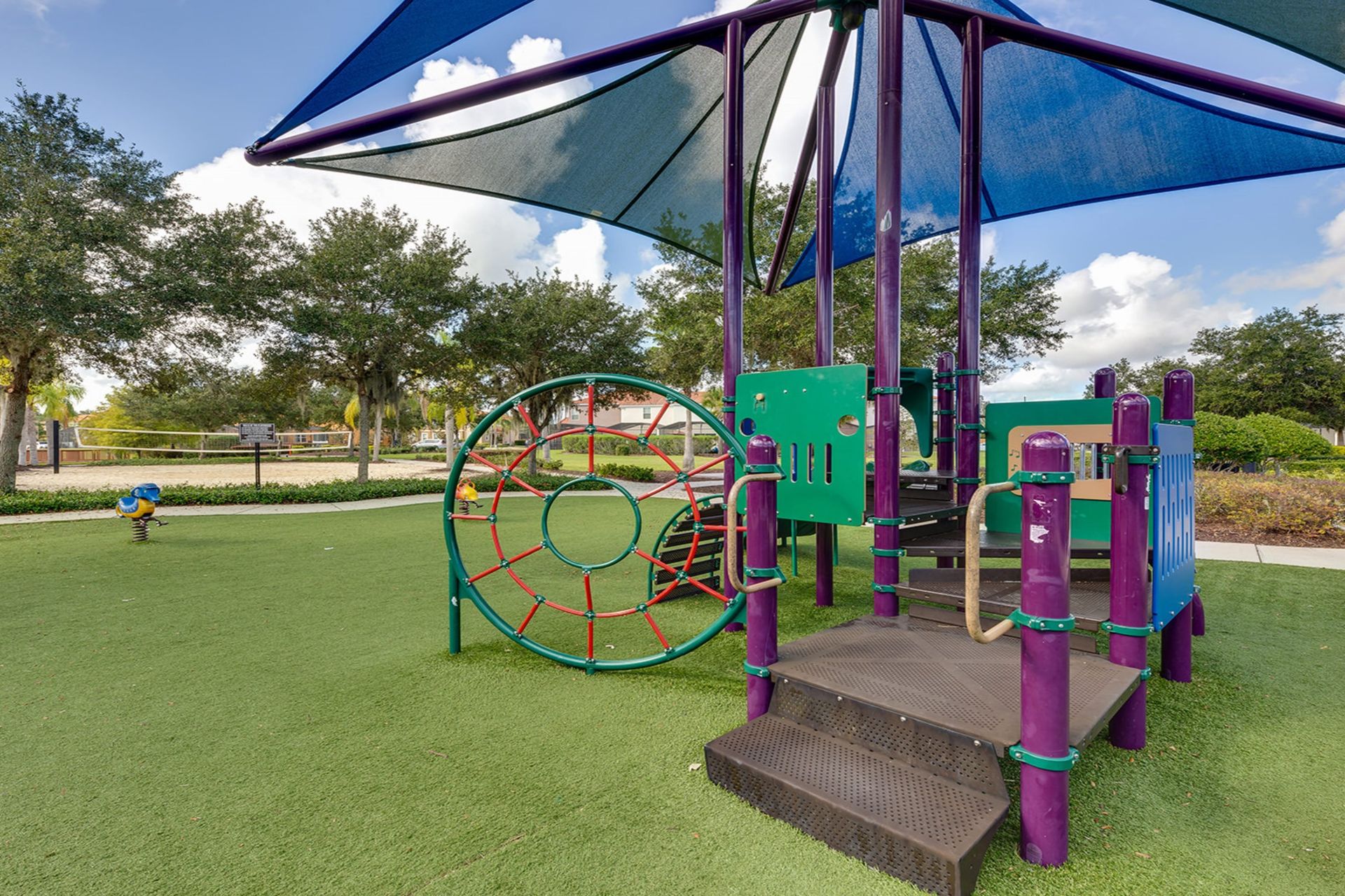 Family fun! Shaded playground & nearby volleyball court await!