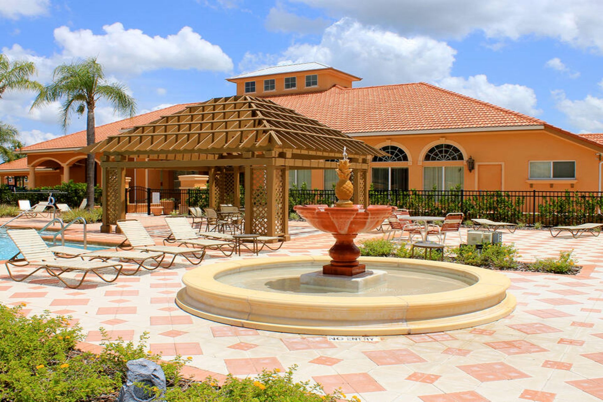 Resort-style retreat! Poolside lounging with a charming fountain.
