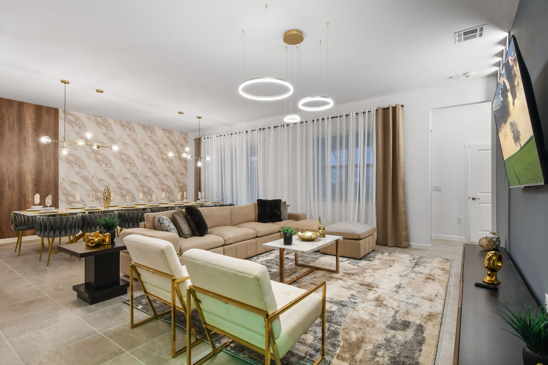 Elegant open-concept living and dining with luxe finishes and designer lighting
