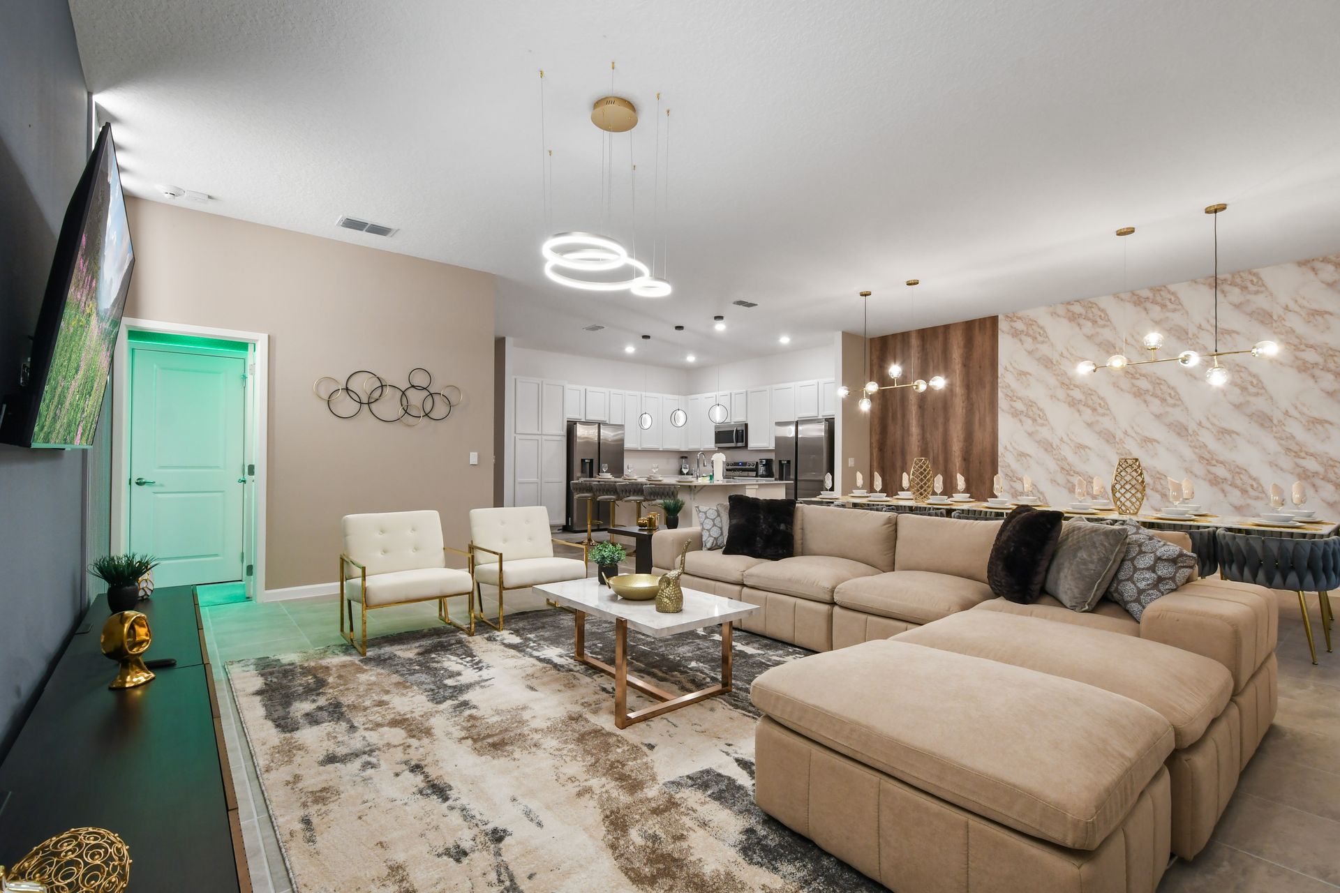 Chic open-plan space with gourmet kitchen, elegant dining, and cozy lounge area
