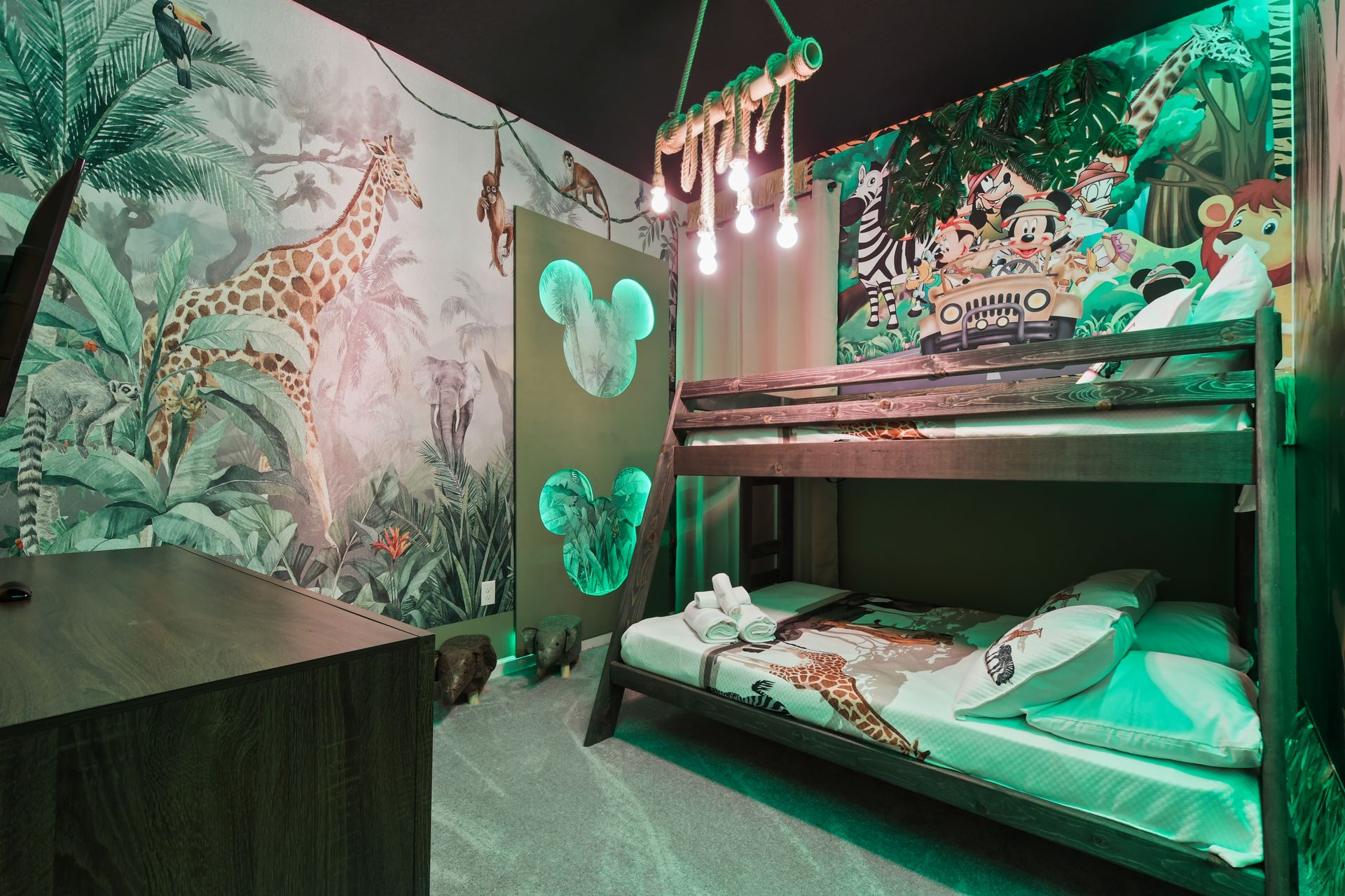 Whimsical jungle-themed kids room with Mickey accents and cozy bunk beds
