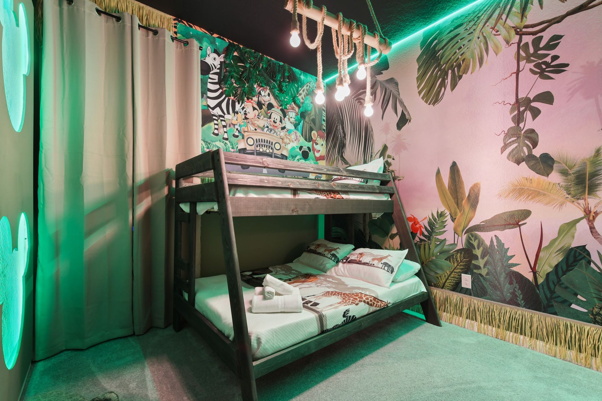 Whimsical jungle-themed kids room with Mickey accents and cozy bunk beds

