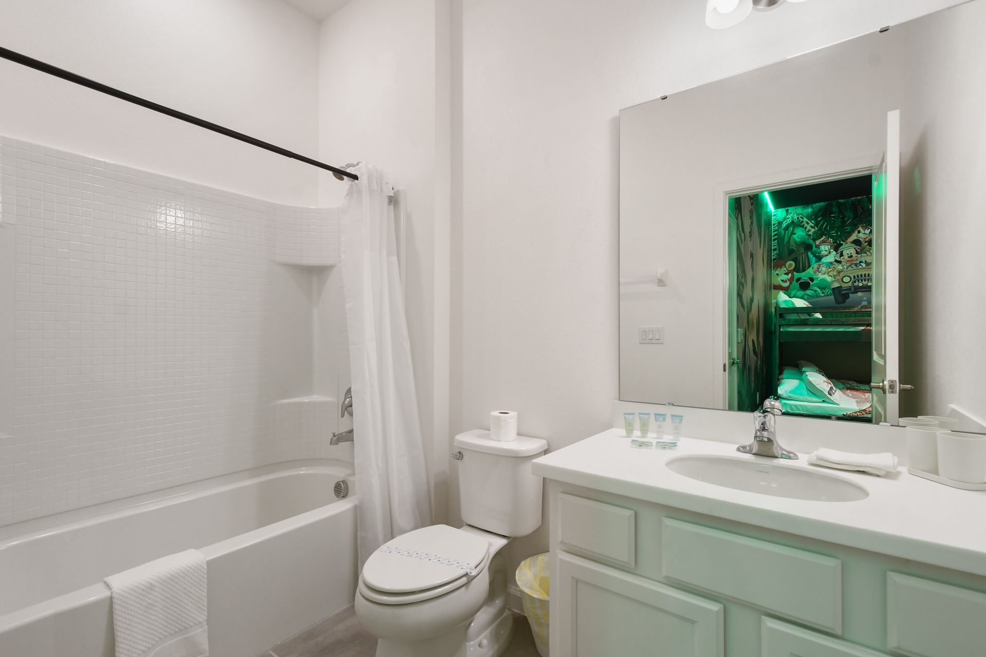 Bright and functional bathroom with tub-shower combo, perfect for the themed kids’ room
