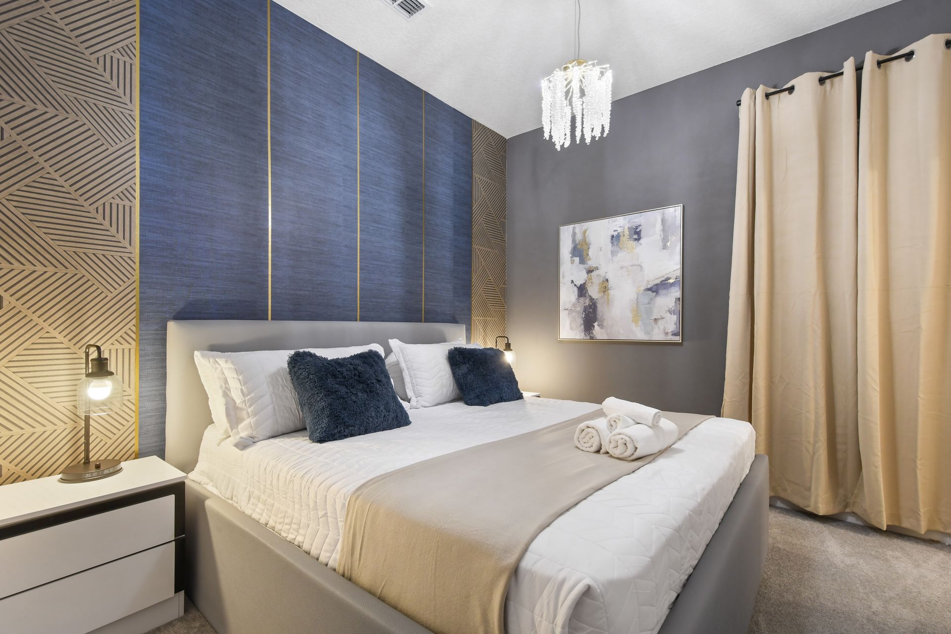 Stylish bedroom with modern textures, ambient lighting, and a cozy king bed
