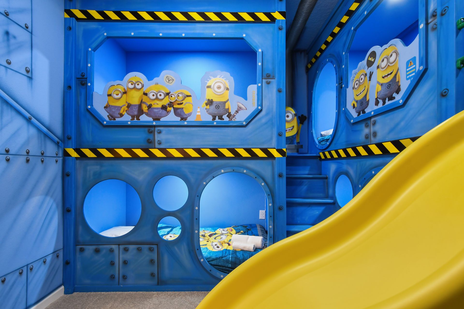 Minion-themed bunk room with slide, tunnels, and bright, playful design
