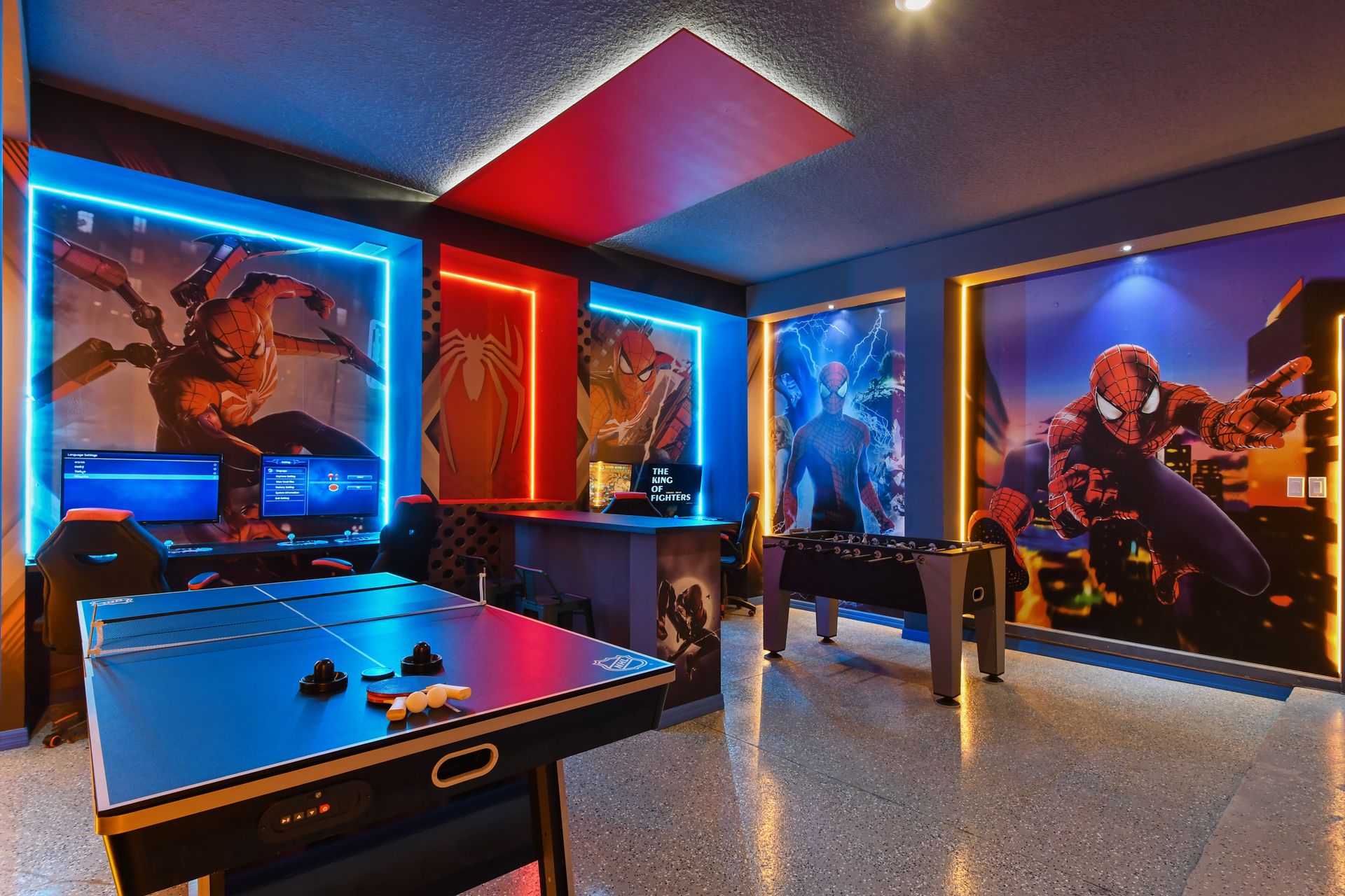 Action-packed Spider-Man game room with air hockey, foosball, and dual gaming stations
