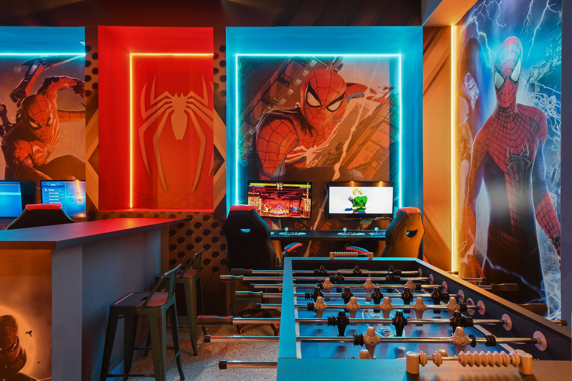 Action-packed Spider-Man game room with air hockey, foosball, and dual gaming stations
