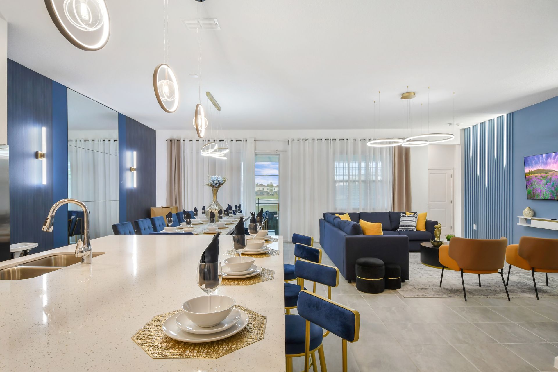 Spacious open-plan kitchen and living area with chic lighting—perfect for entertaining!