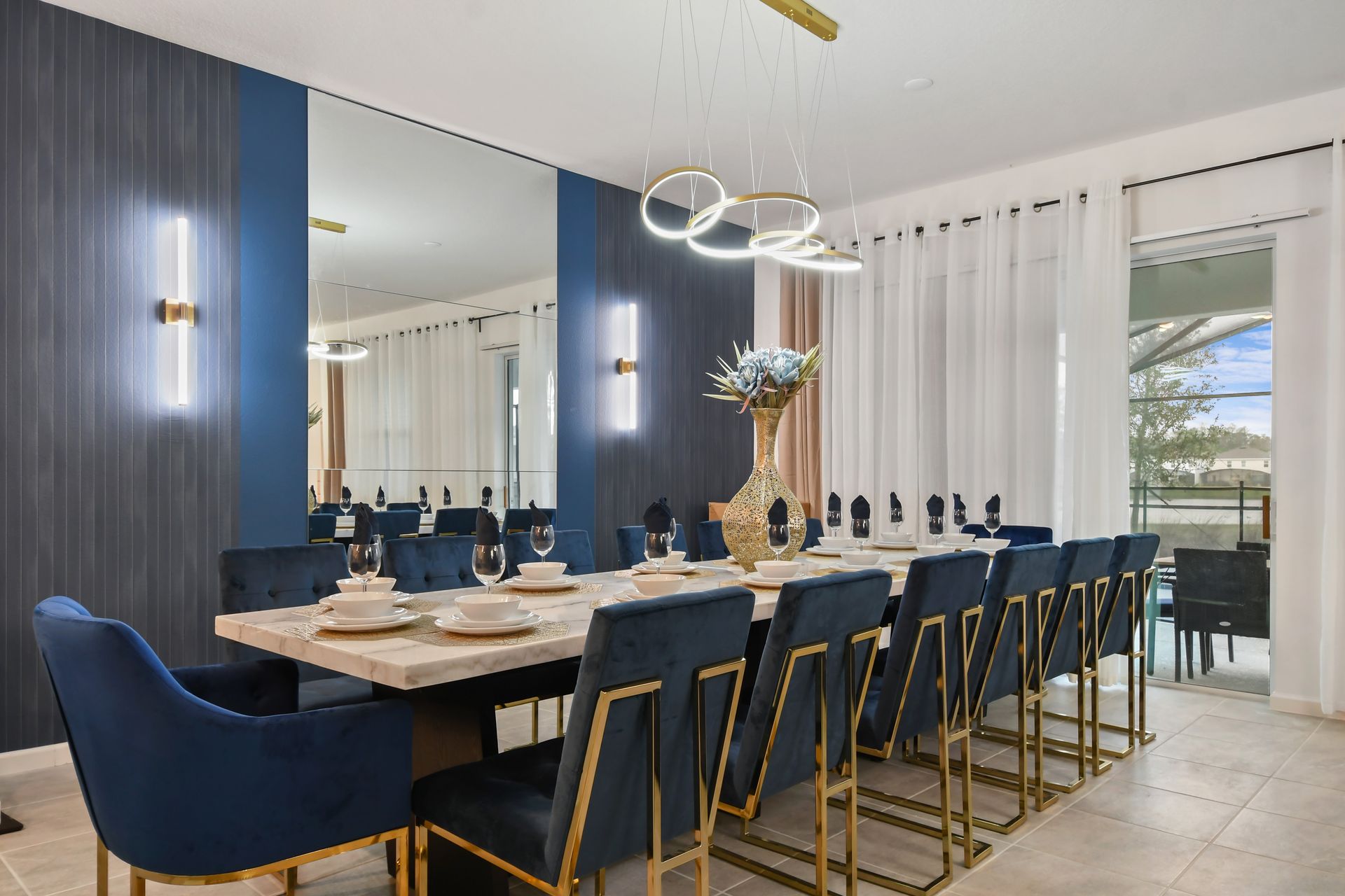 Elegant dining room with velvet chairs, gold accents, and mirror wall—dine in style!