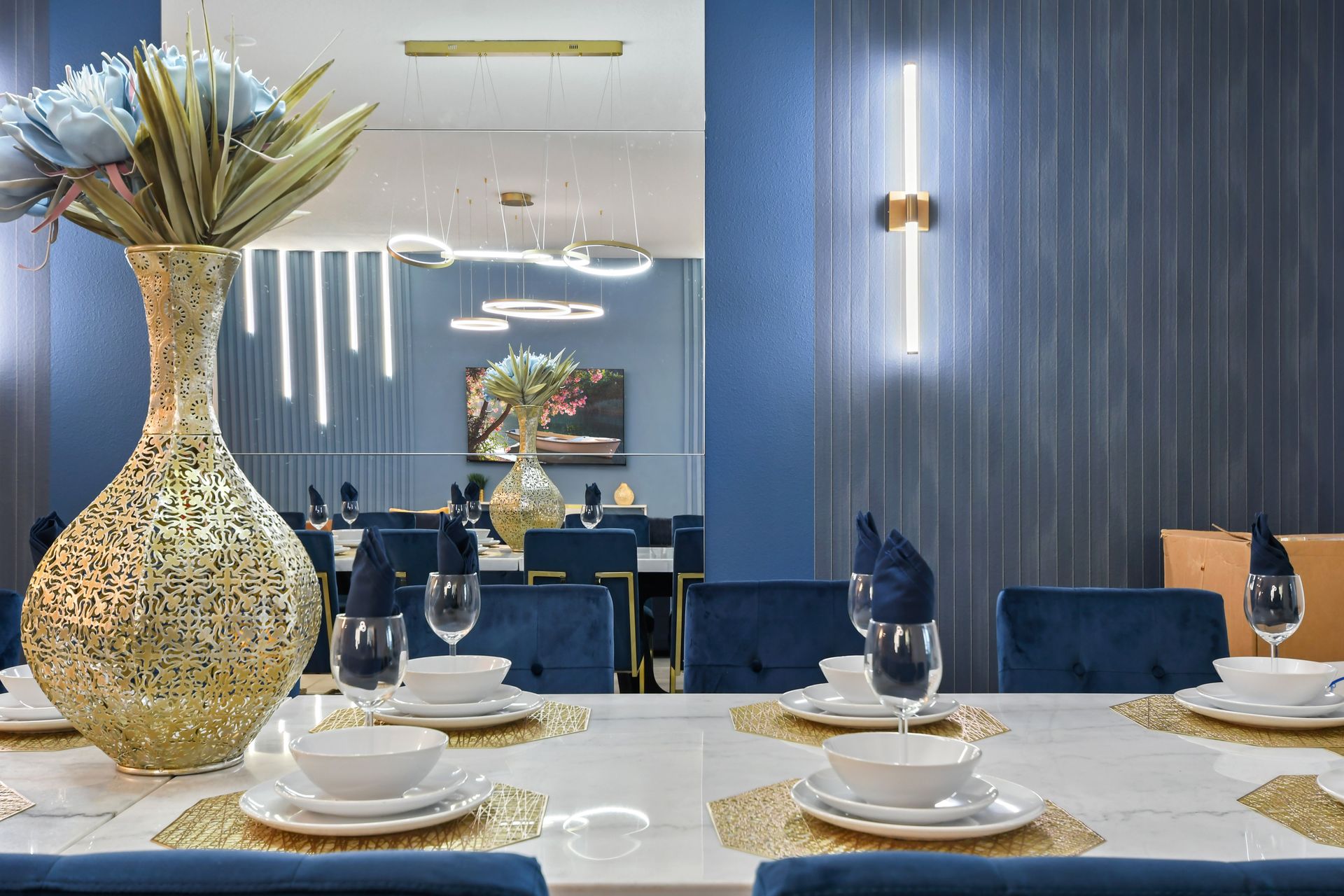 Elegant dining area with gold accents, plush seating, and mirror detail—dine in luxury!