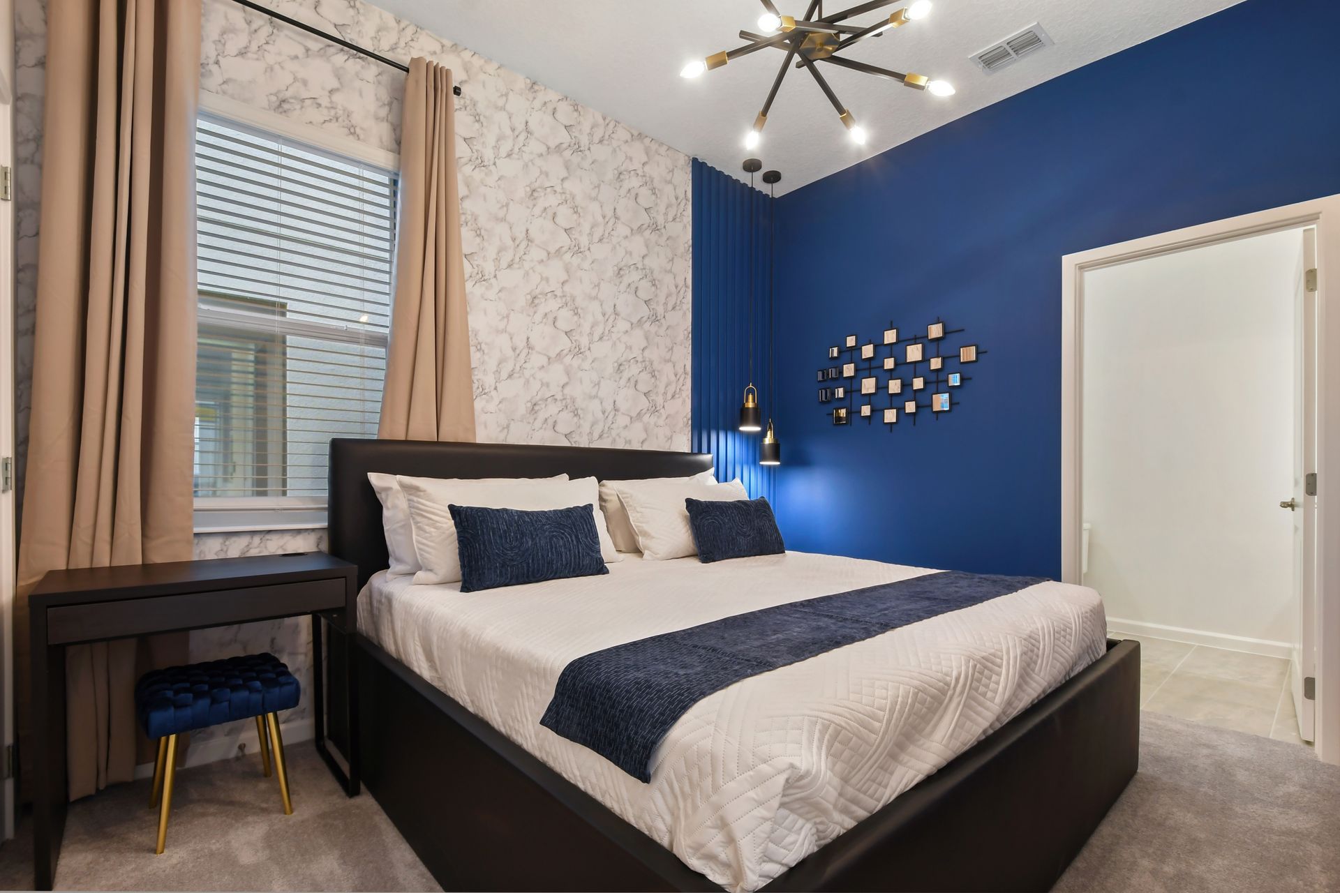 Chic bedroom with bold blue accents, modern lighting, and cozy vibes—rest in style!