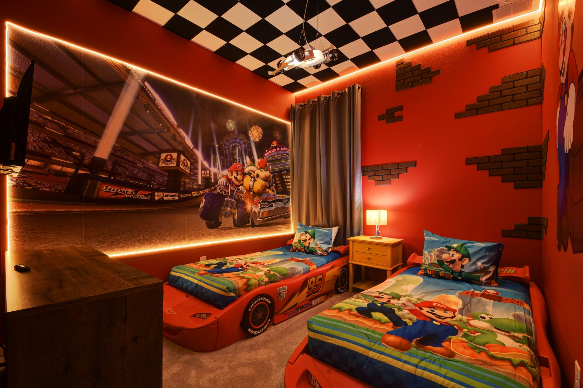 Racing-themed kids' room with car beds, LED lights, and game decor—fun at full speed!