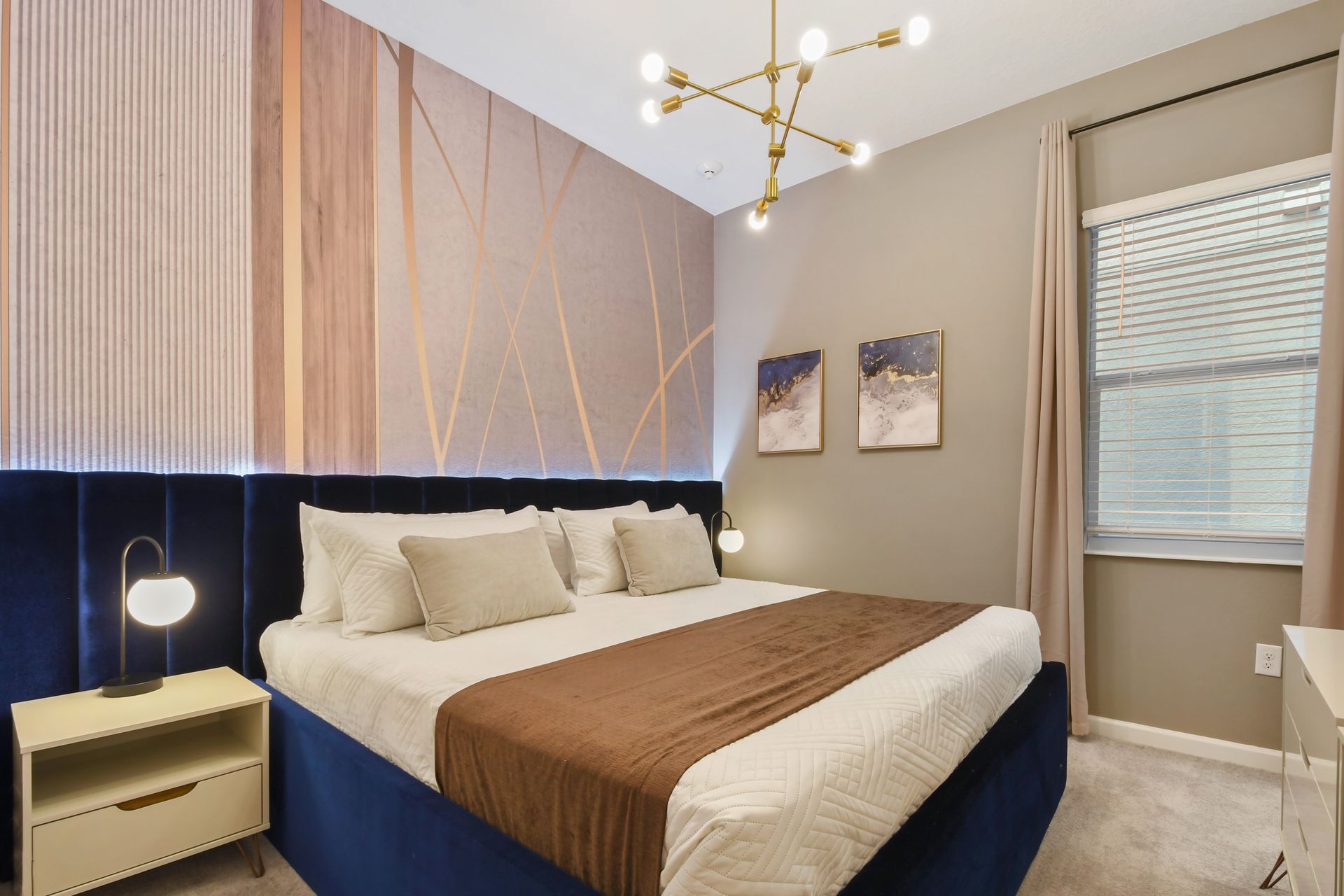 Elegant bedroom with abstract art, soft tones, and luxurious bedding—serene retreat