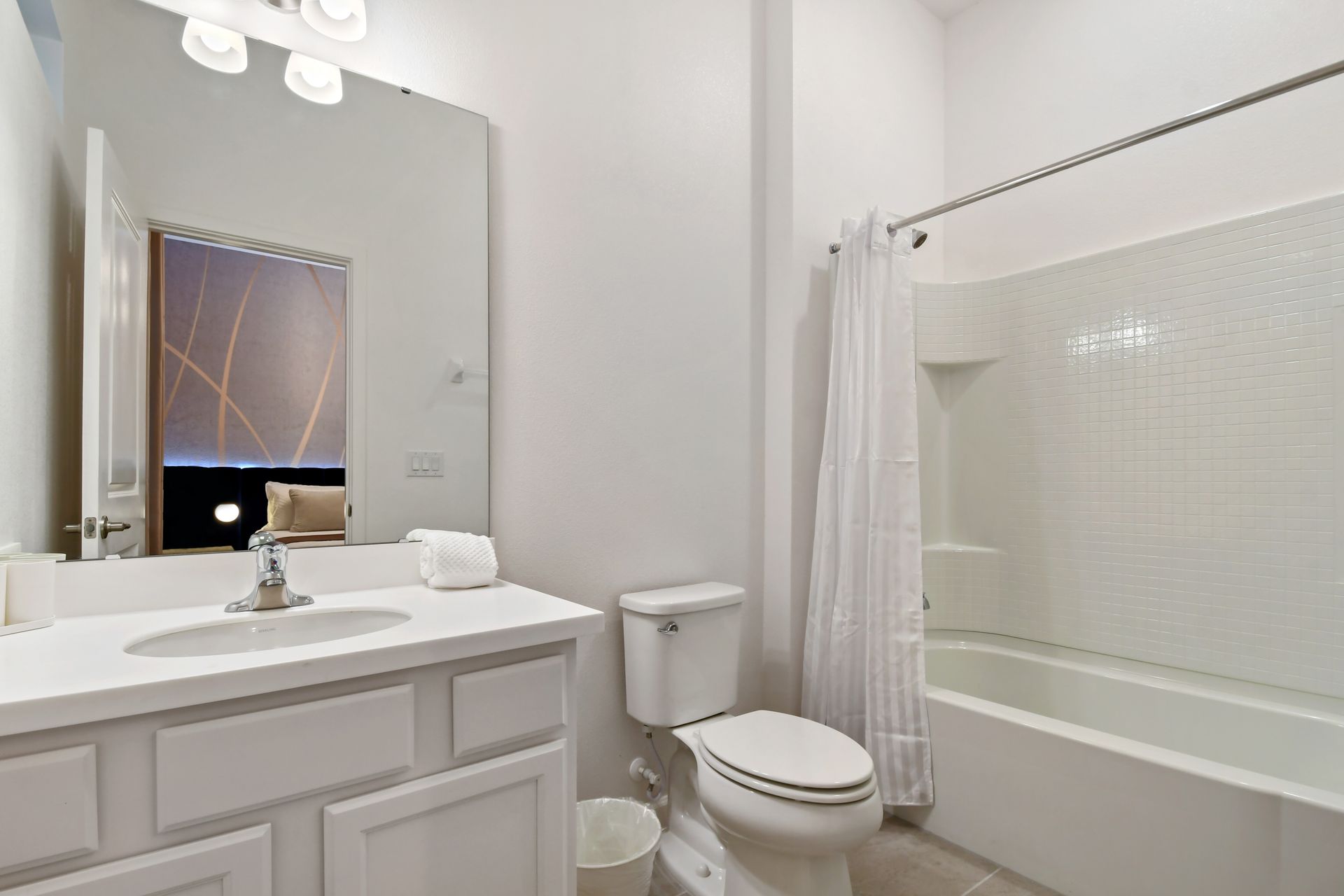 Bright and spotless bathroom with a clean tub and modern white finishes.