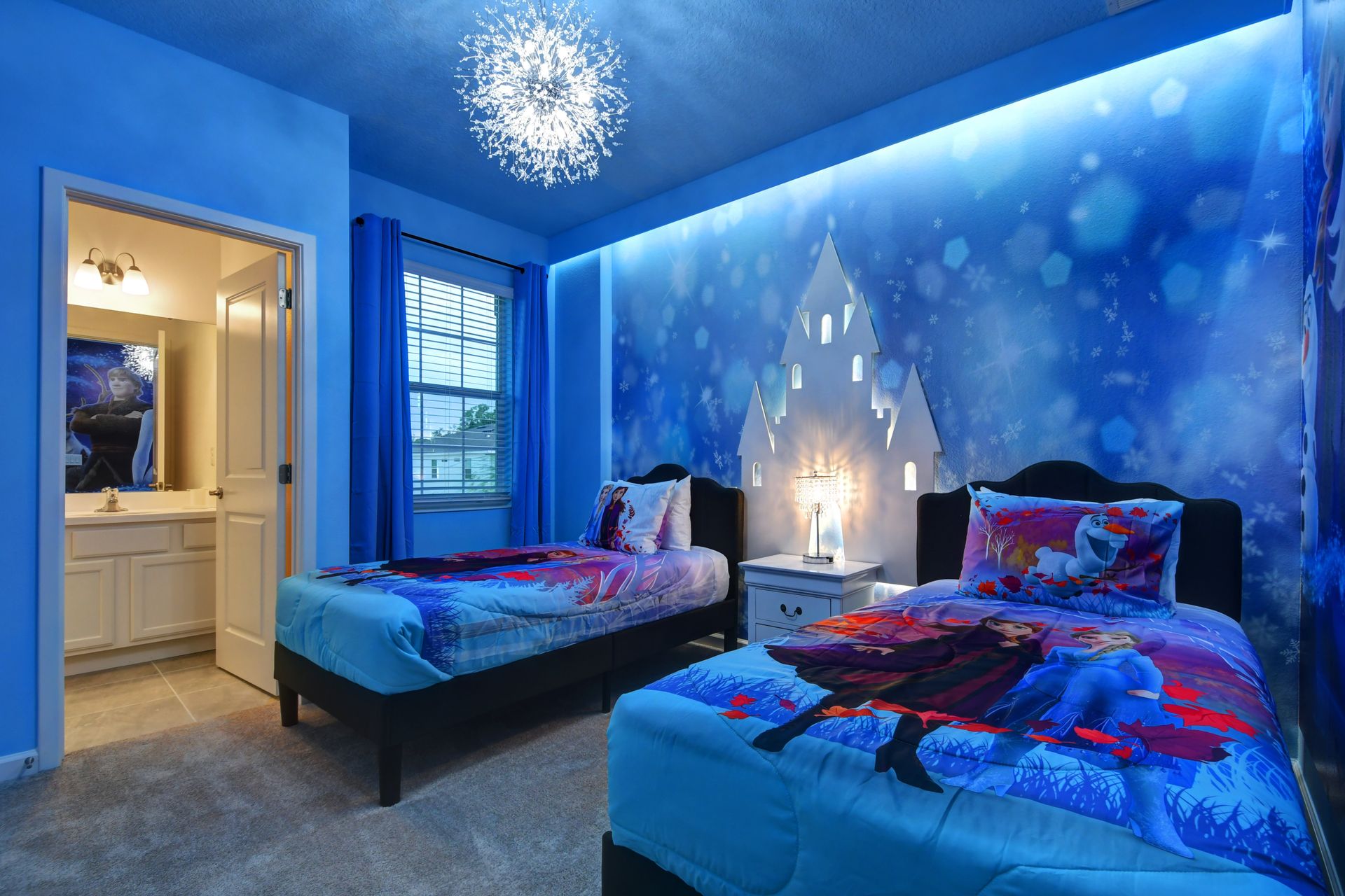 Frozen-themed bedroom with snowflake lighting and castle decor—magical for kids