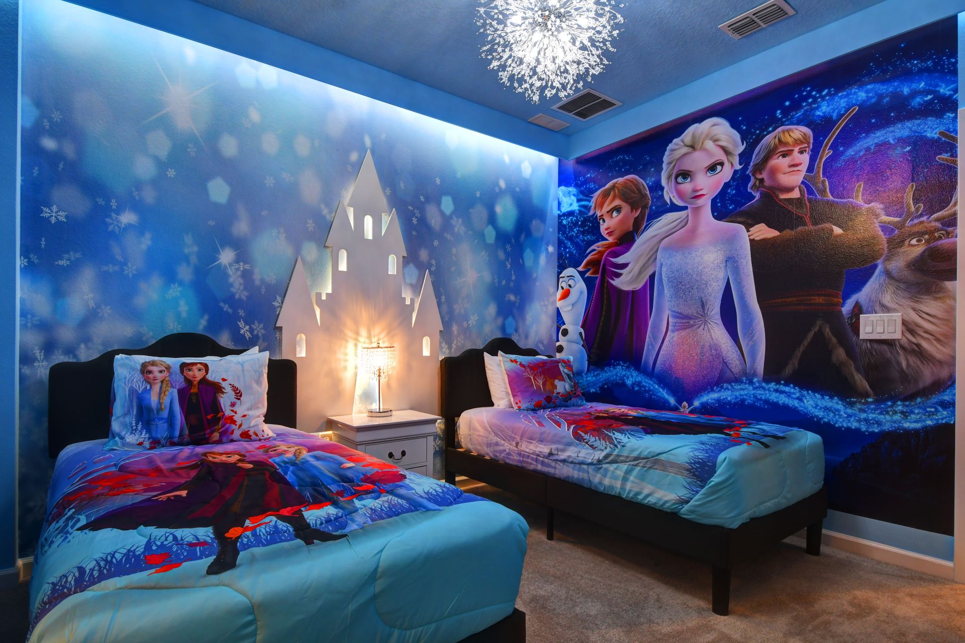 Frozen-themed bedroom with snowflake lighting and castle decor—magical for kids