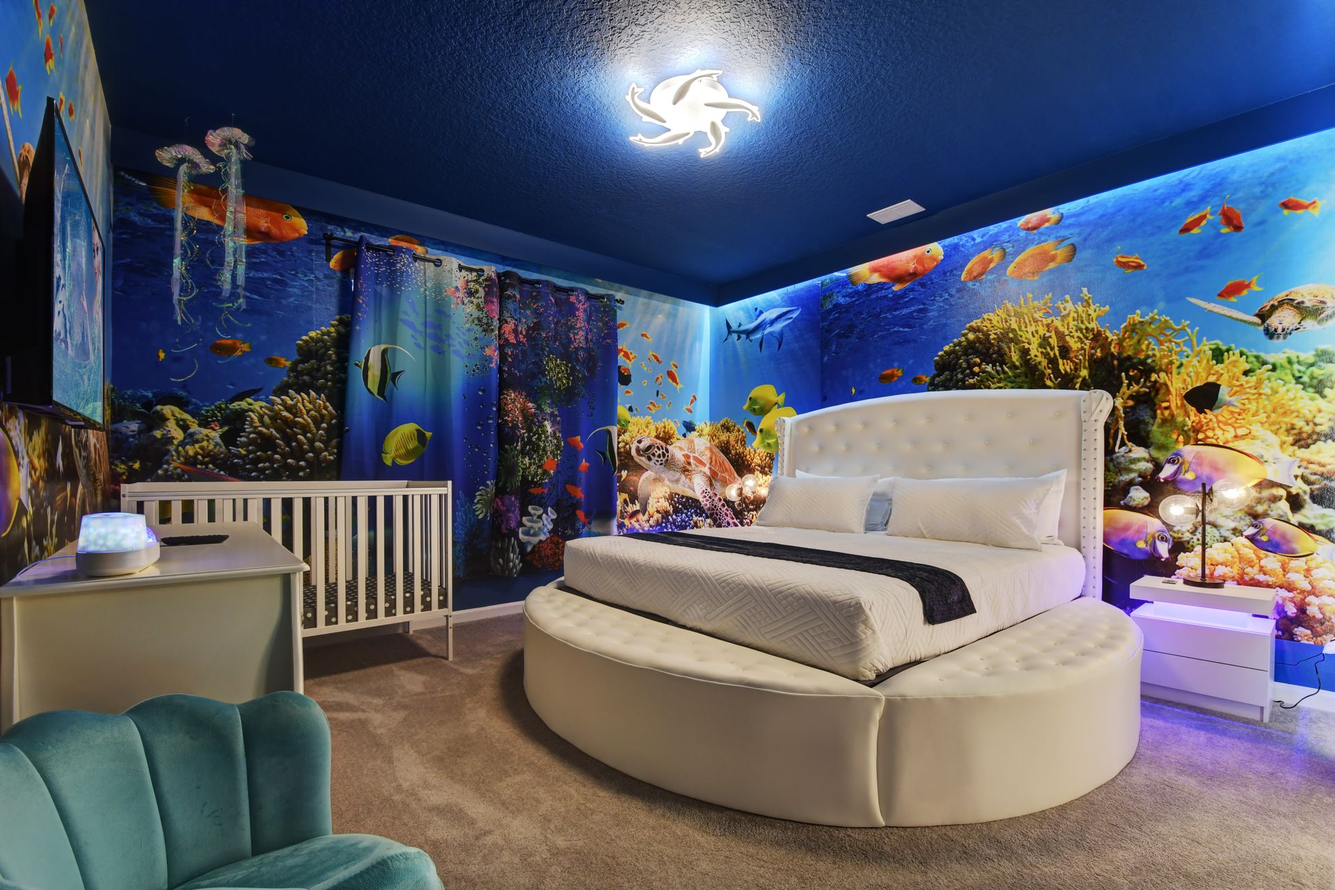 Underwater-themed bedroom with ocean murals and soft lighting—dive into relaxation