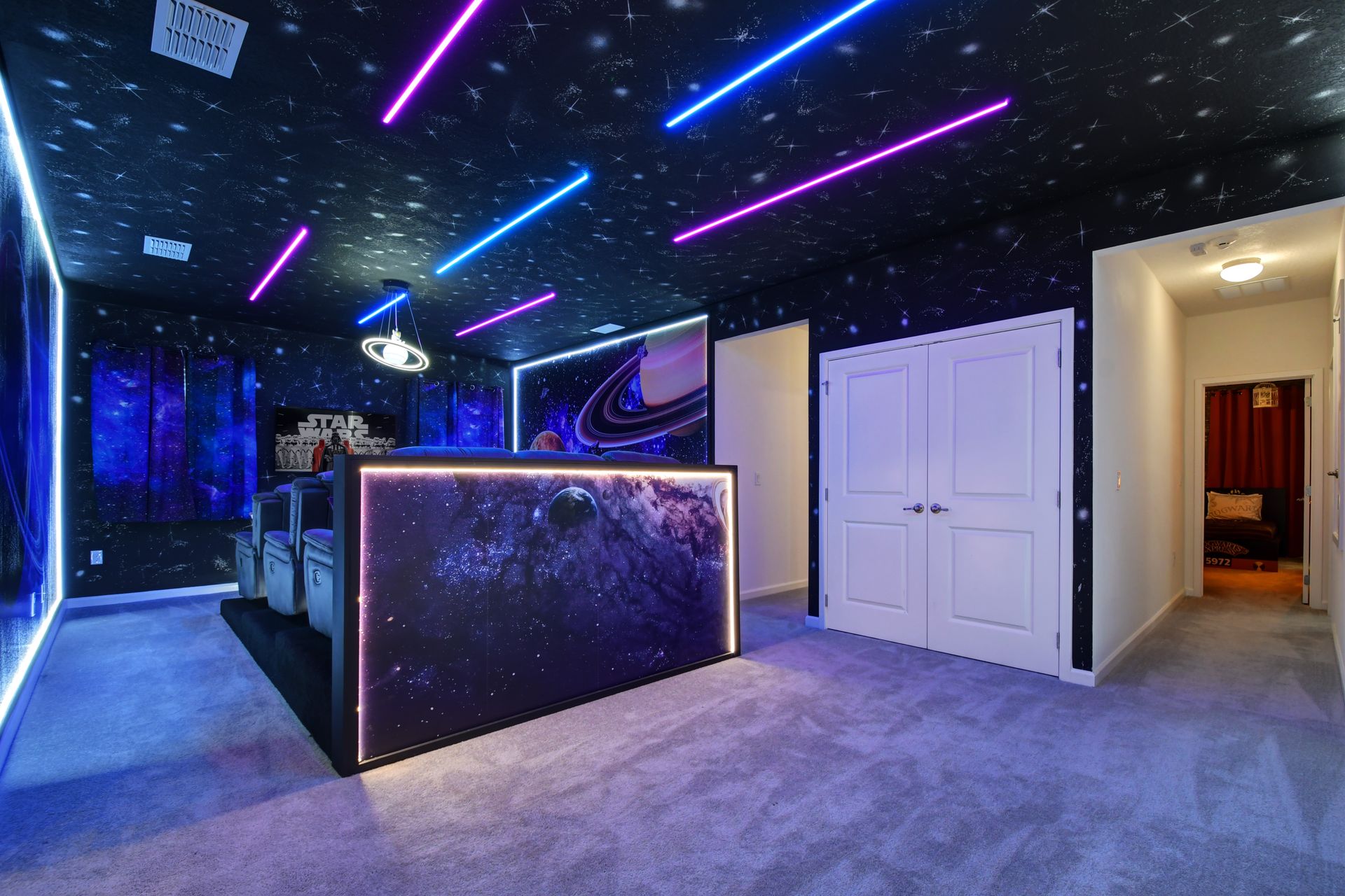 Futuristic home theater with galaxy theme, LED lights, and recliners—cinematic escape!