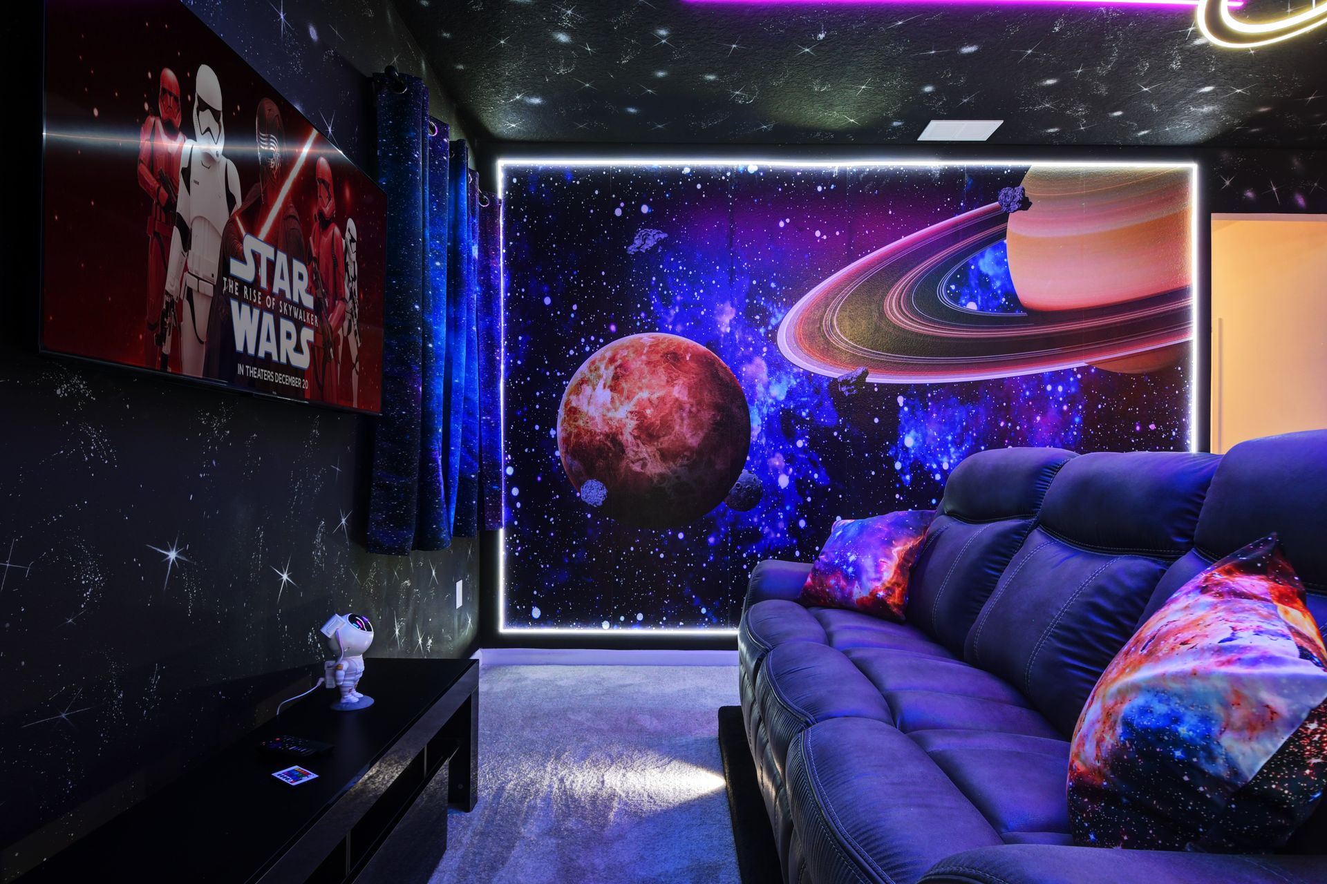 Galaxy-themed home theater with LED lights—immerse in space and movie magic!