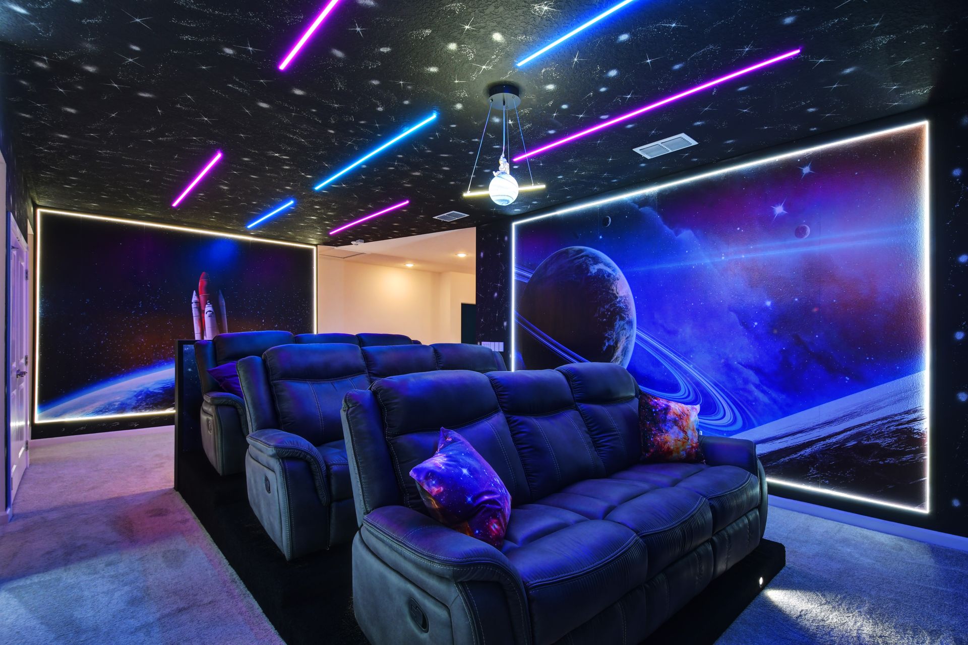 Space-themed home theater with LED lights and recliners—blast off into movie magic!