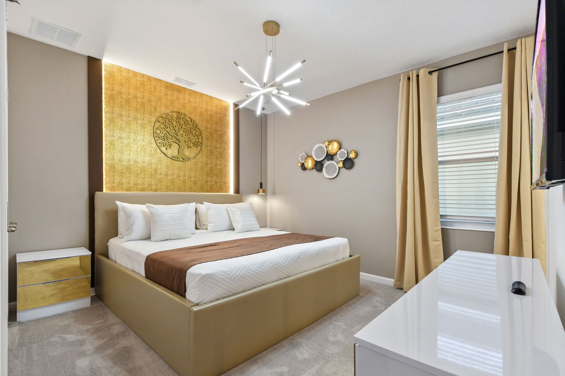 Luxurious bedroom with gold accents, modern lighting, and cozy bedding—elegant retreat