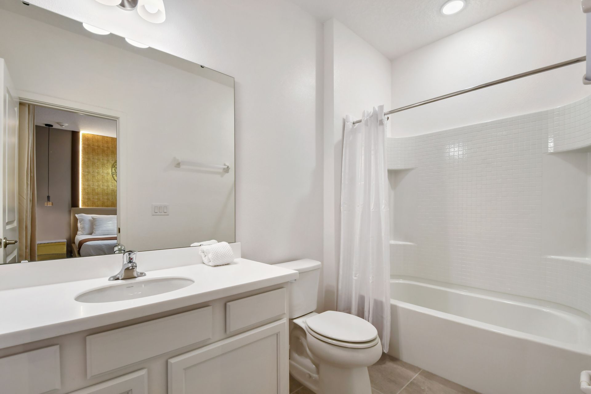 Bright and clean bathroom with modern fixtures and a relaxing shower-tub combo.