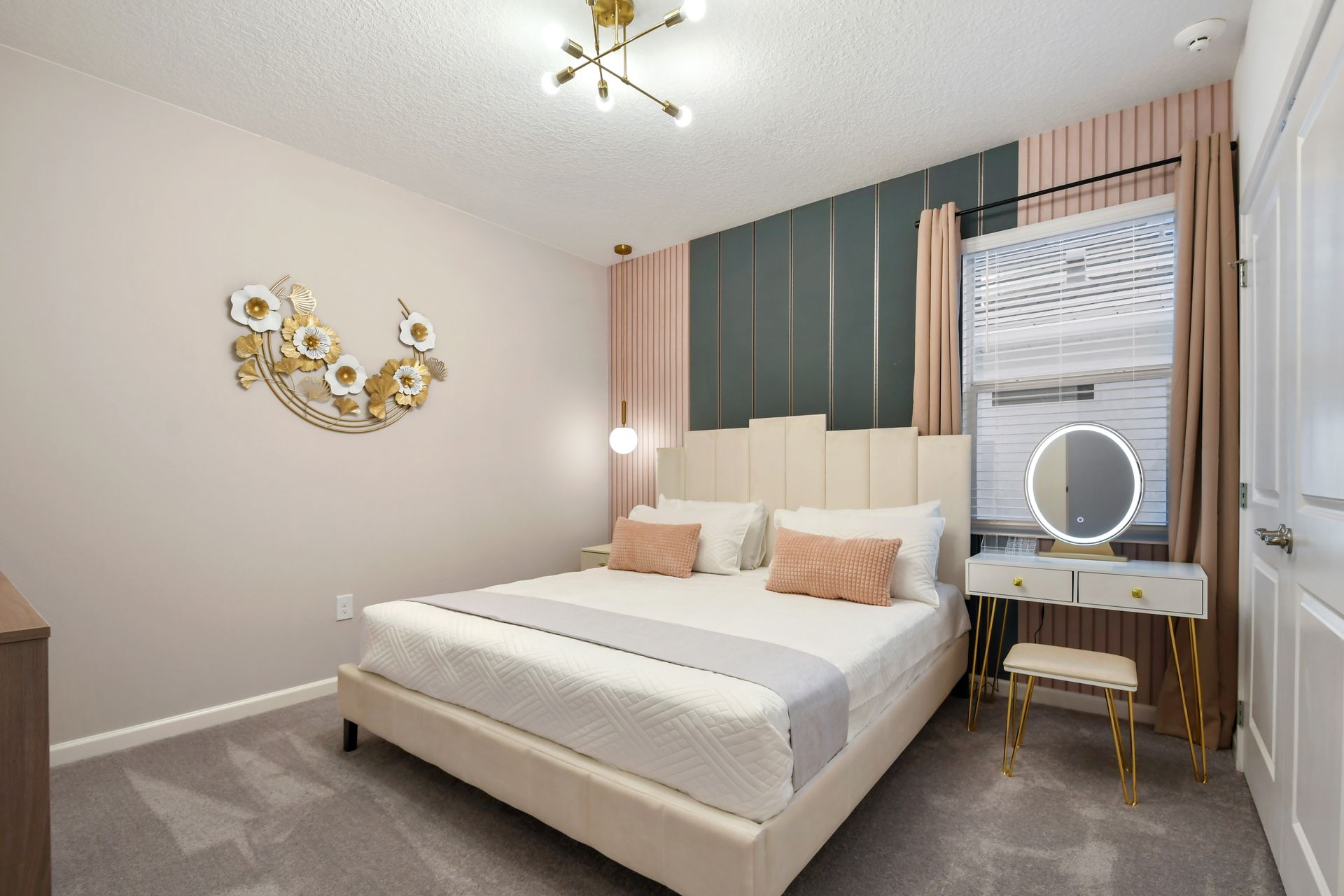 Charming bedroom with soft pastels, gold accents, and a vanity—elegant and cozy