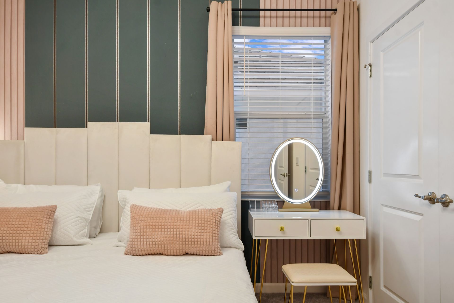 Modern elegance with soft hues, gold accents, and a chic lighted vanity.