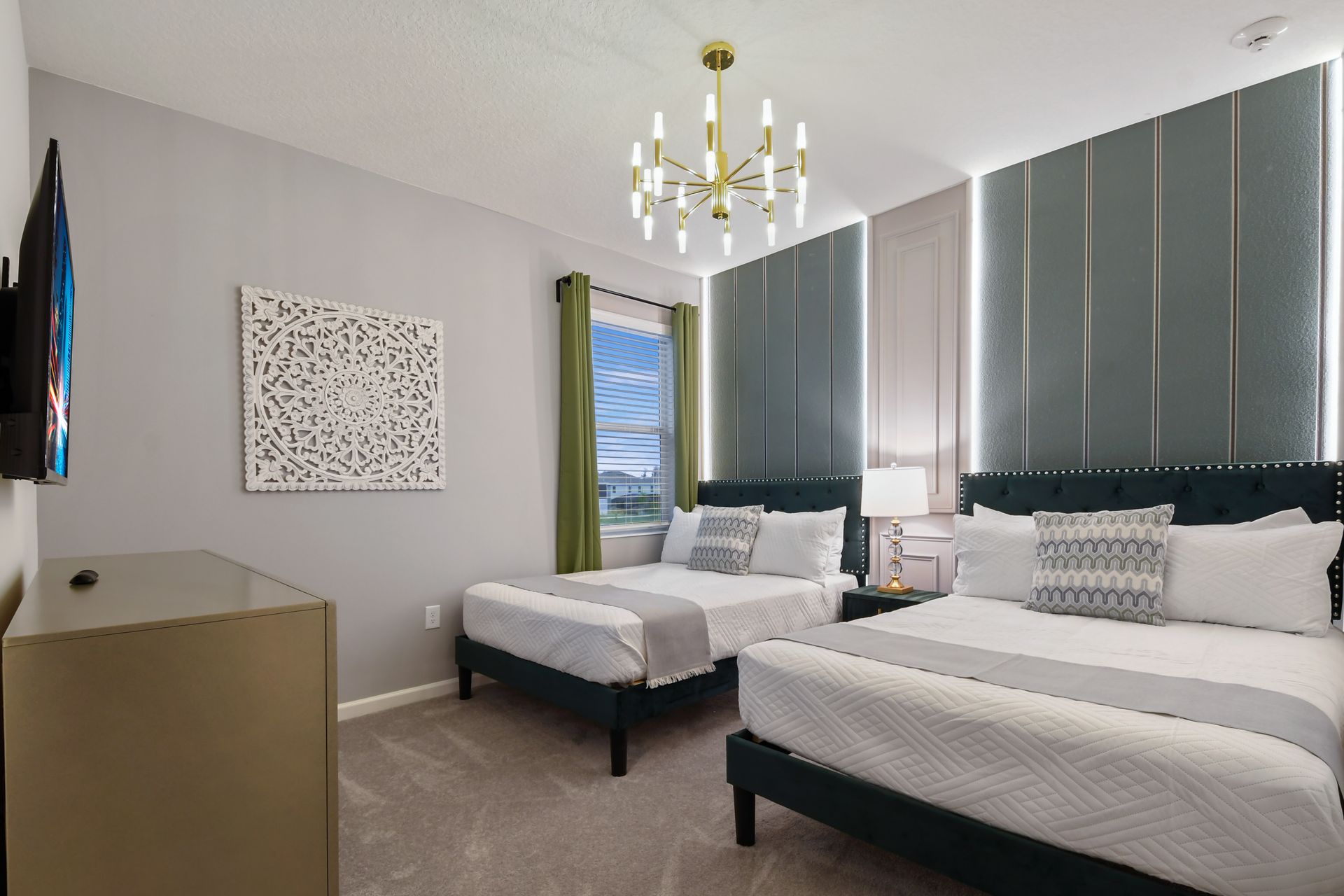 Chic room with twin beds, elegant lighting, and sophisticated green accents.