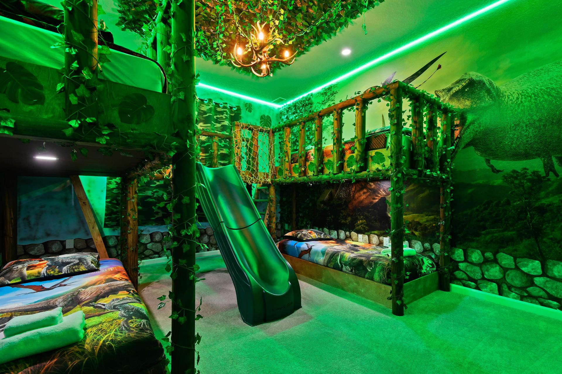 Jungle-themed room with bunk beds, slide, and green lighting—wild adventure awaits