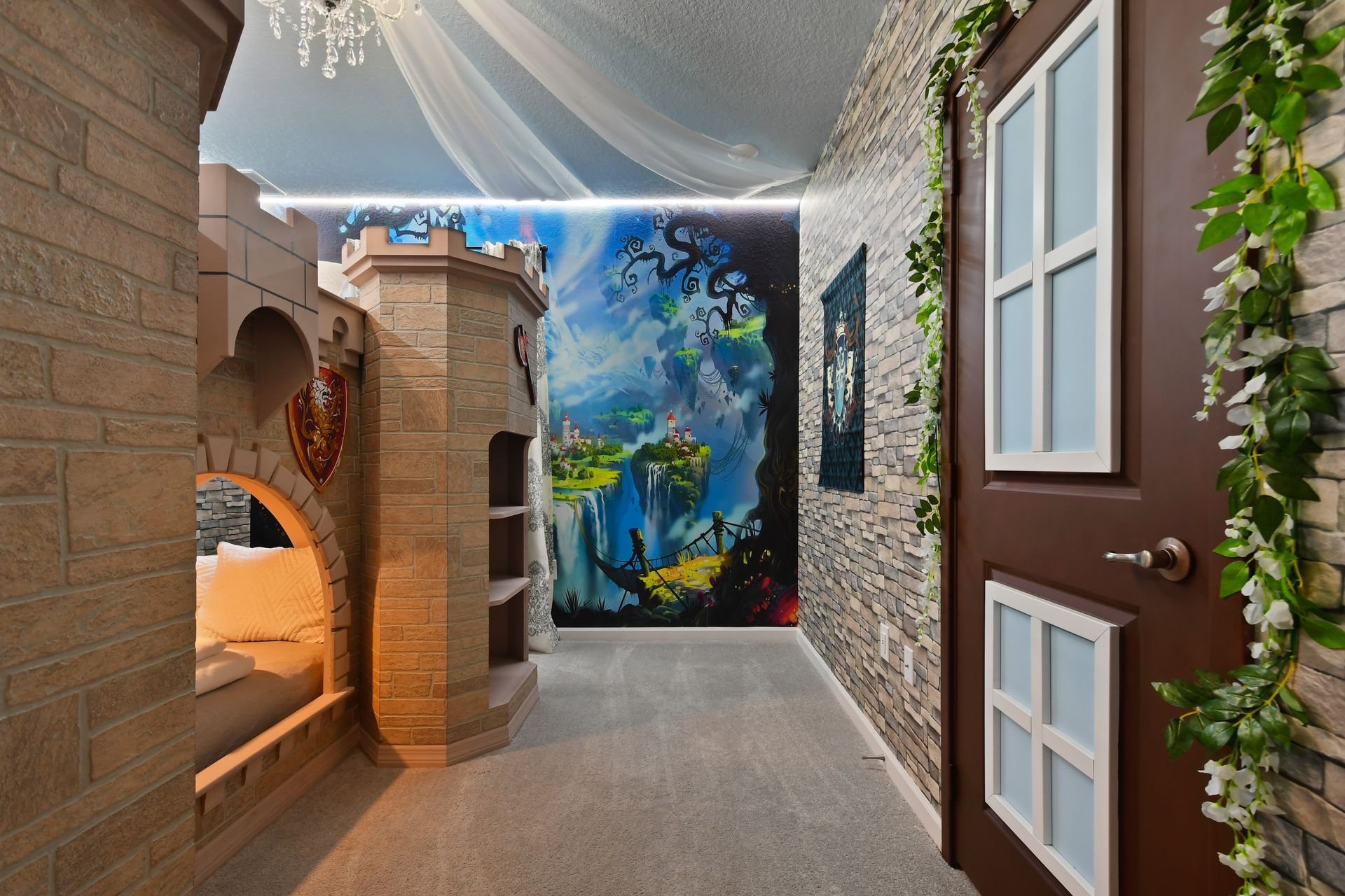 Castle-themed bedroom with stone walls, cozy nook, and chandelier—fairytale escape