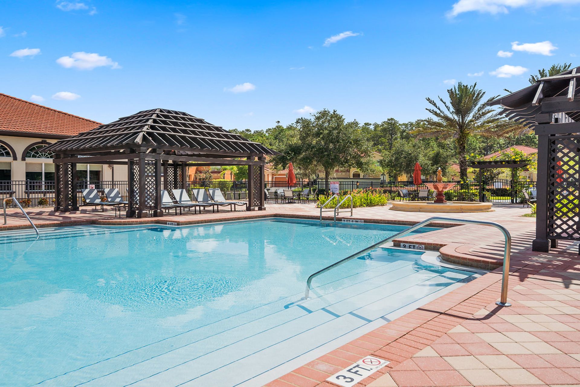 Luxurious poolside retreat with cabanas, loungers, and palm views!