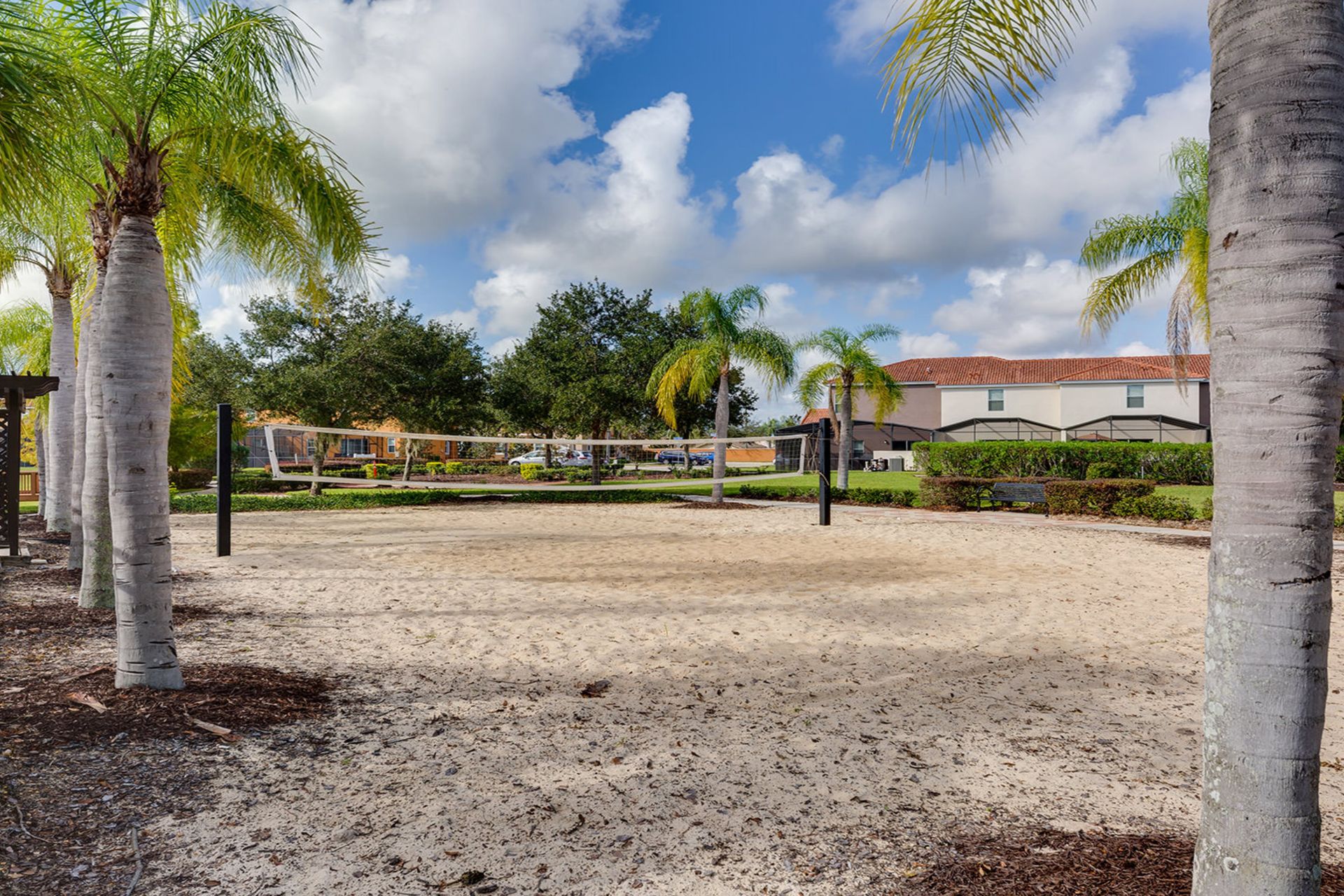 Relax & play! Palm-lined sand volleyball court in sunny paradise.