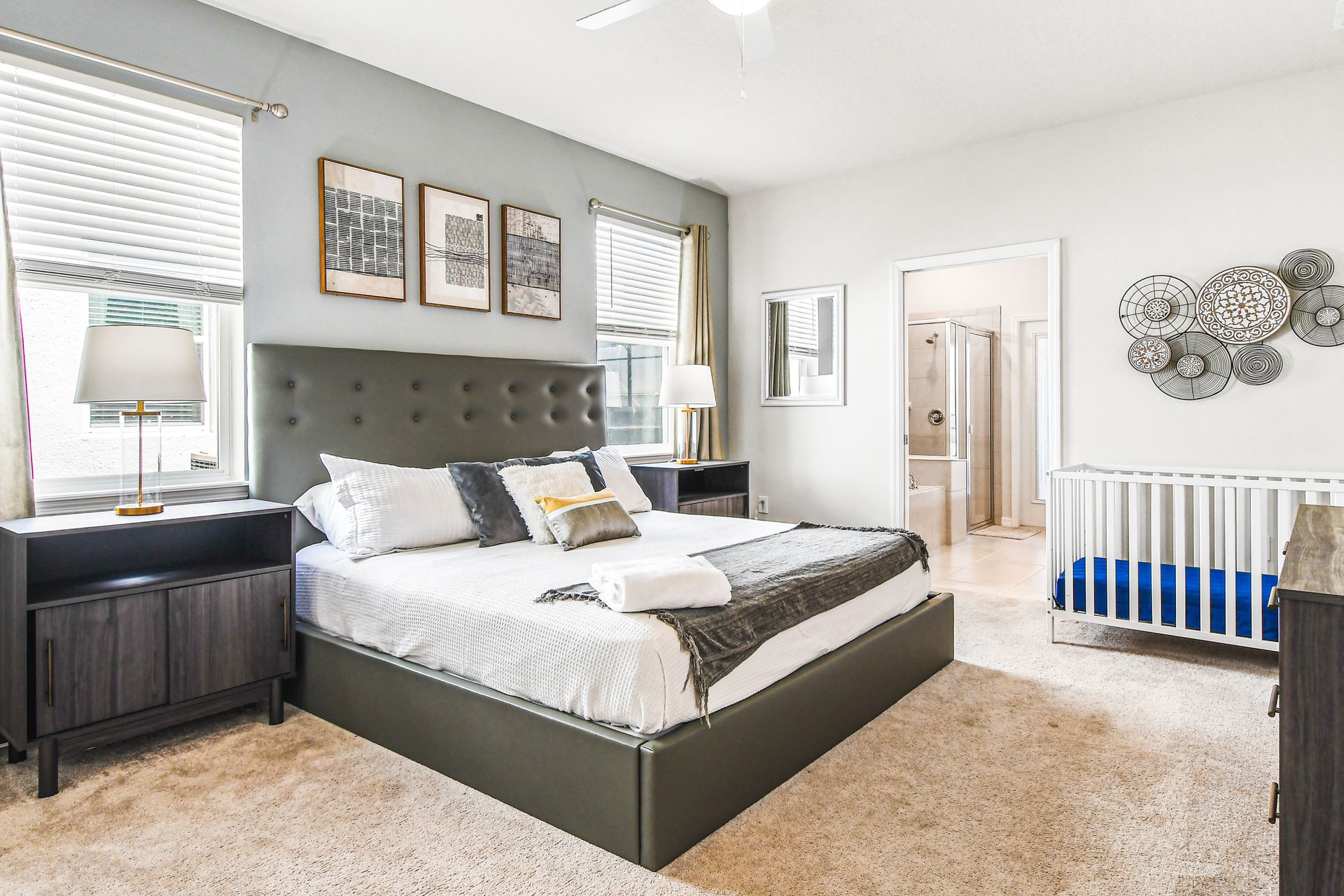 Modern master suite with ensuite bathroom and cozy crib corner