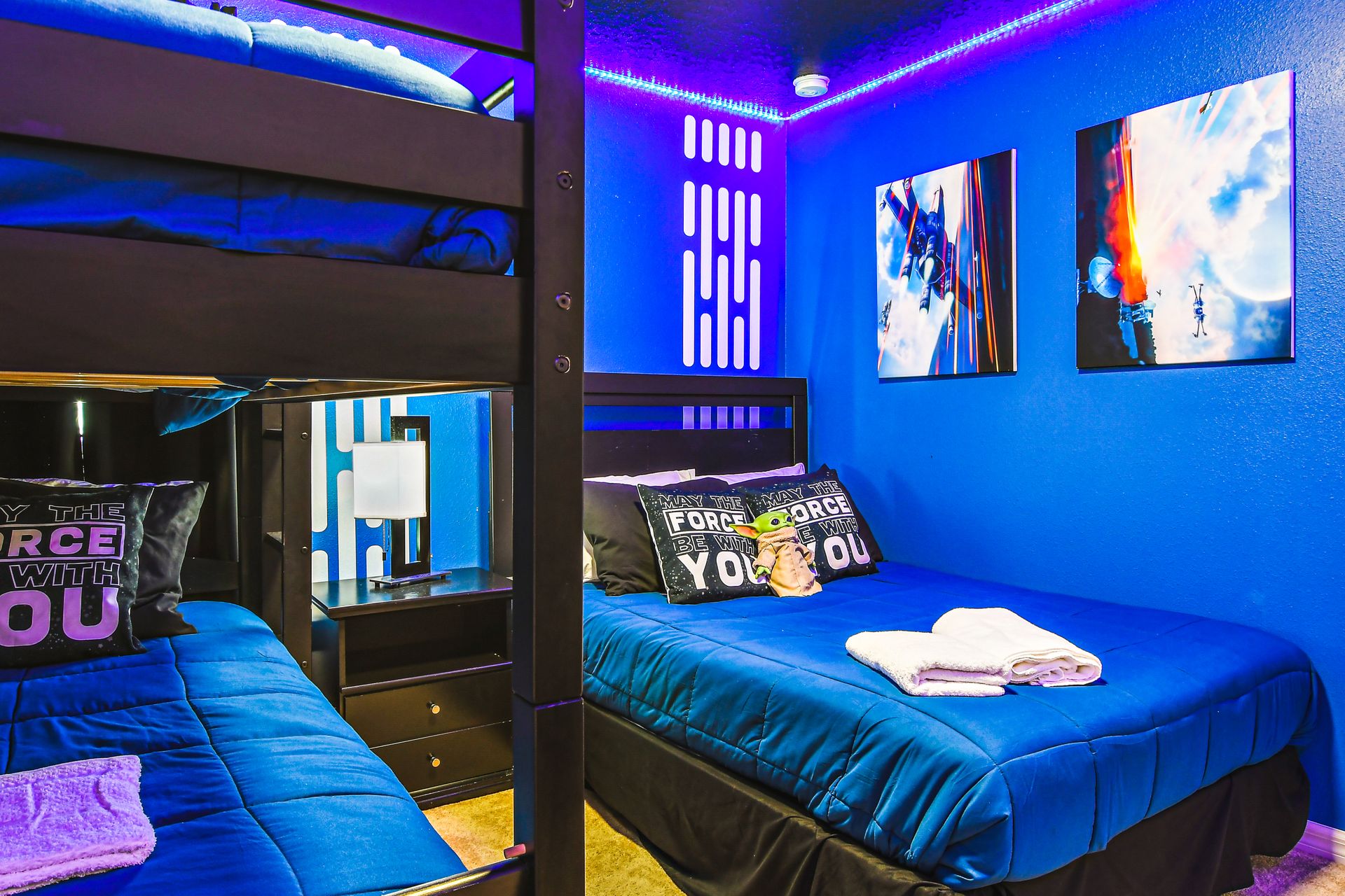 Galaxy-themed bedroom with bunk beds and vibrant LED lighting