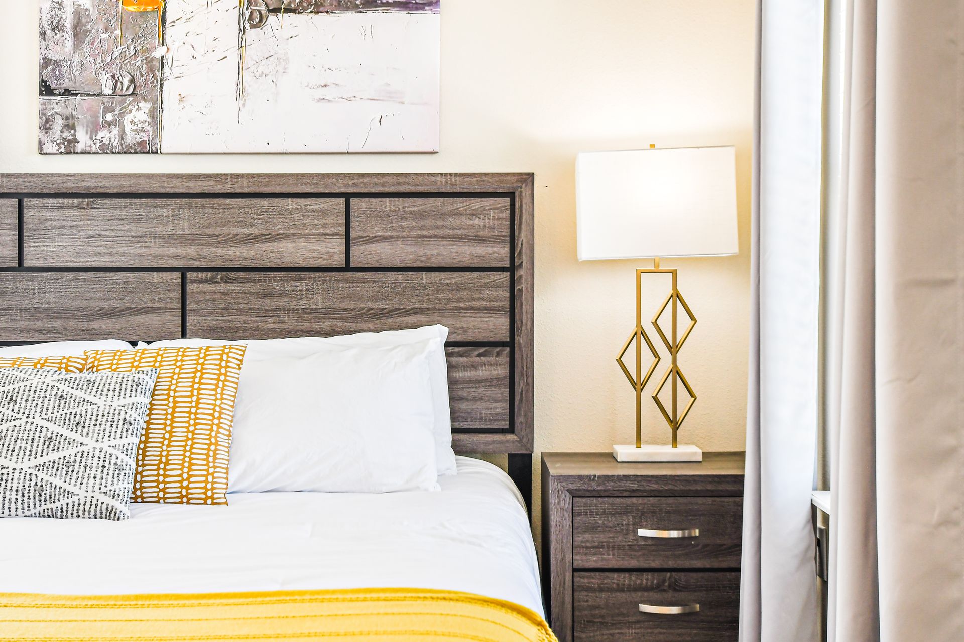 Sophisticated bedroom with bold accents and warm lighting.