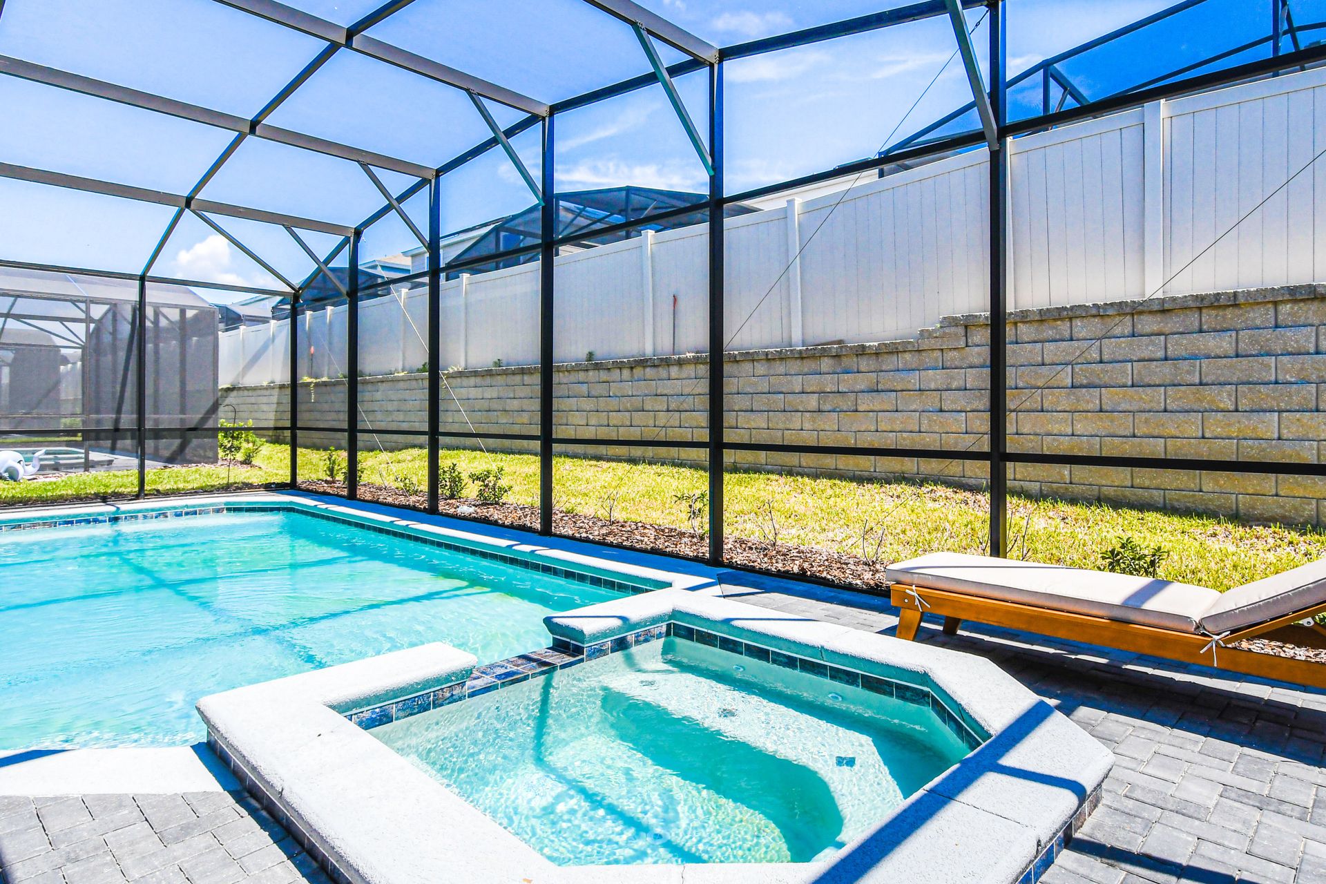 Enjoy sun-soaked days by the pool in a tranquil outdoor setting.