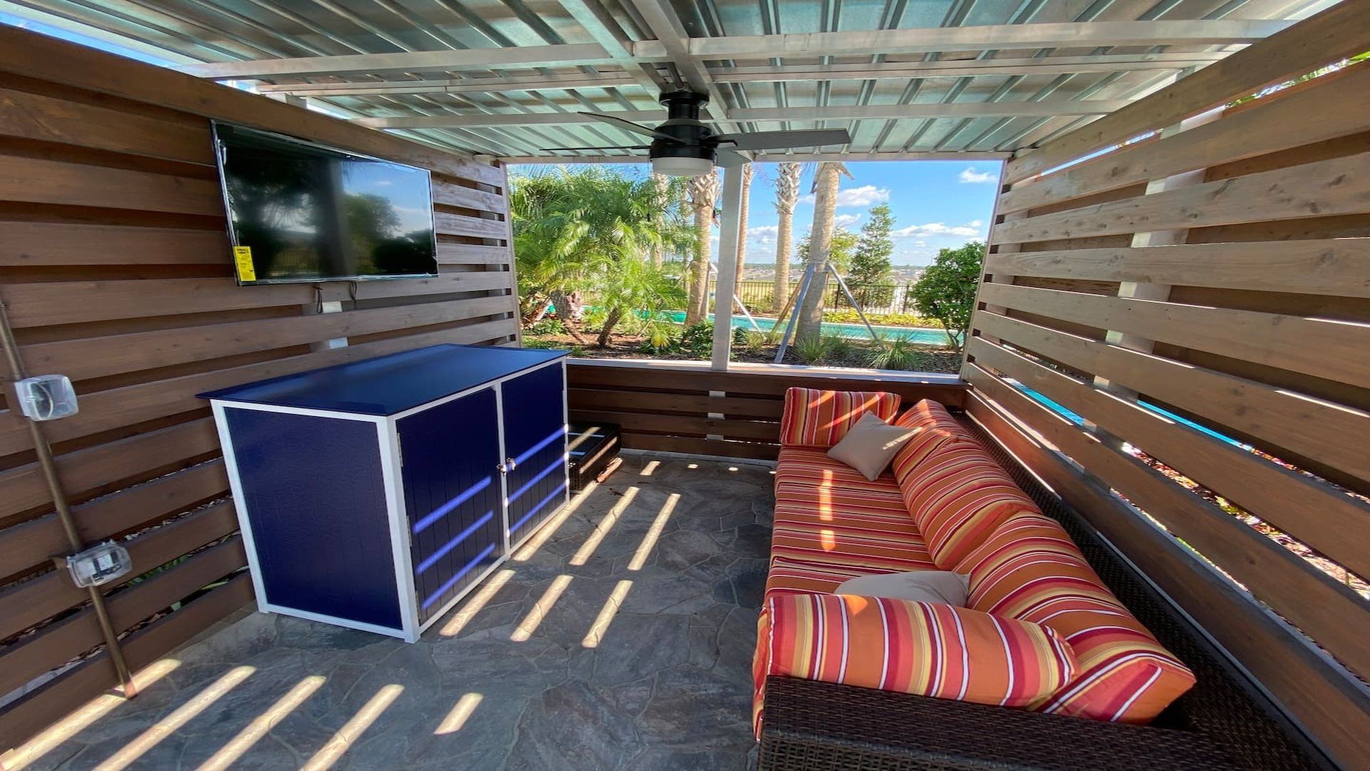 Relax in a private cabana with cozy seating and TV amenities!