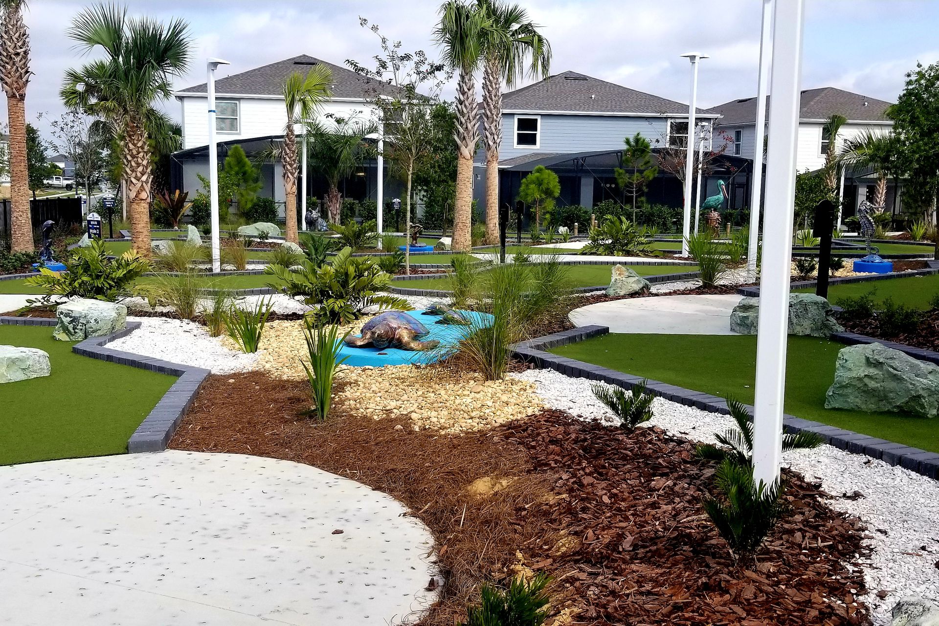 Tropical mini-golf surrounded by lush palm trees.