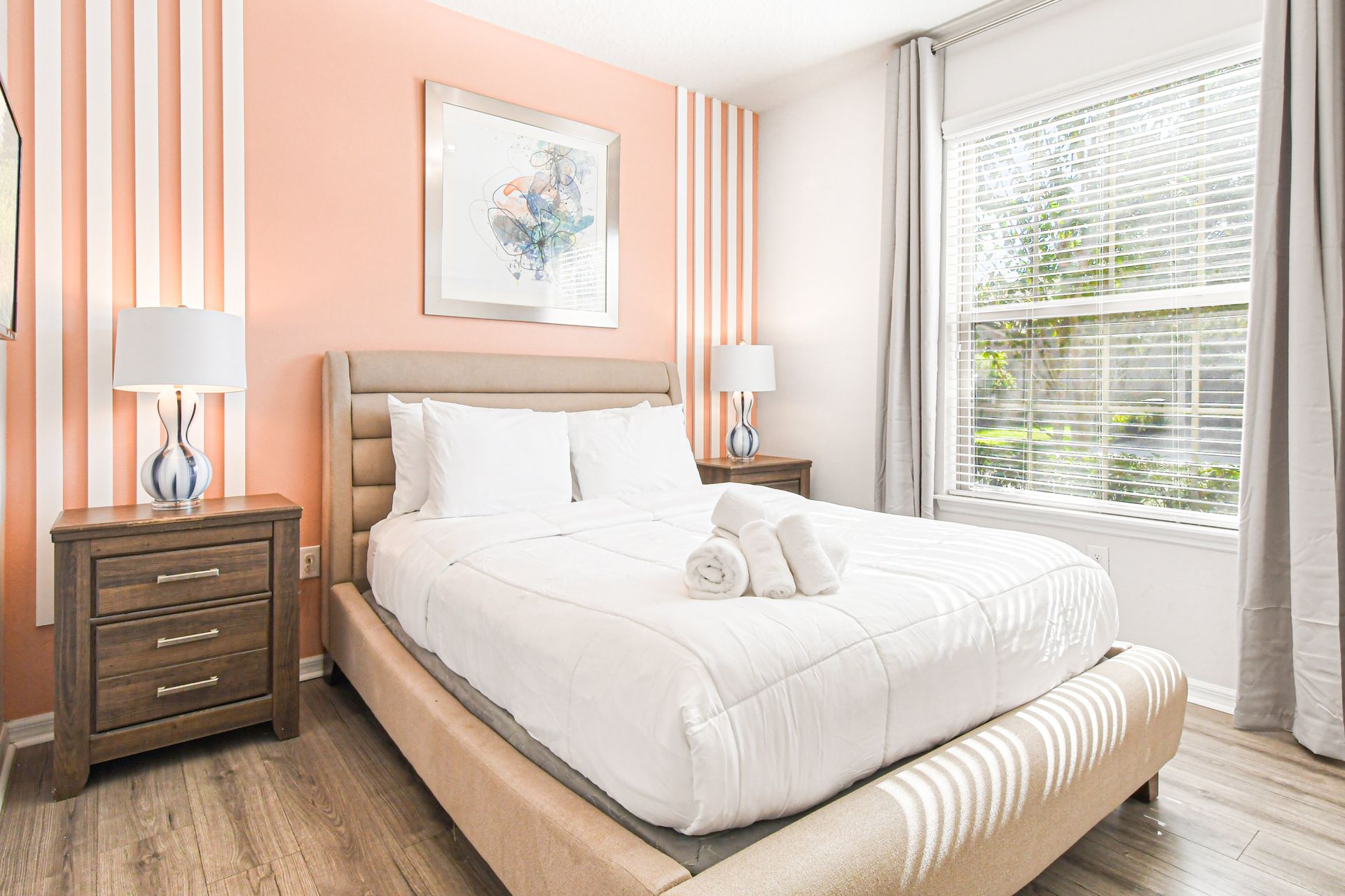 Stylish bedroom with fresh design, comfortable bed, and abundant natural light.