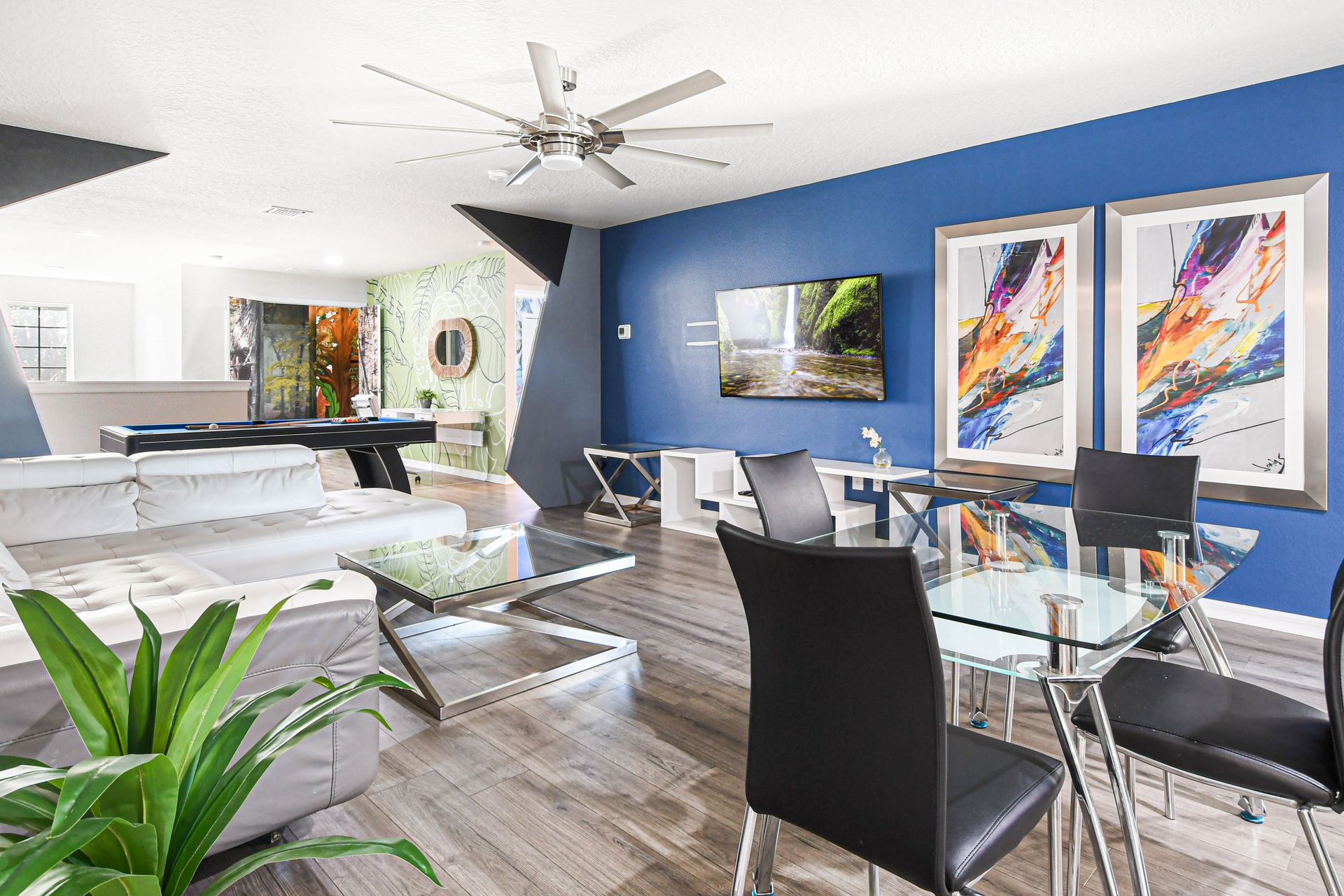 Stylish open-plan loft with bold accents, modern seating, and a sleek pool table.