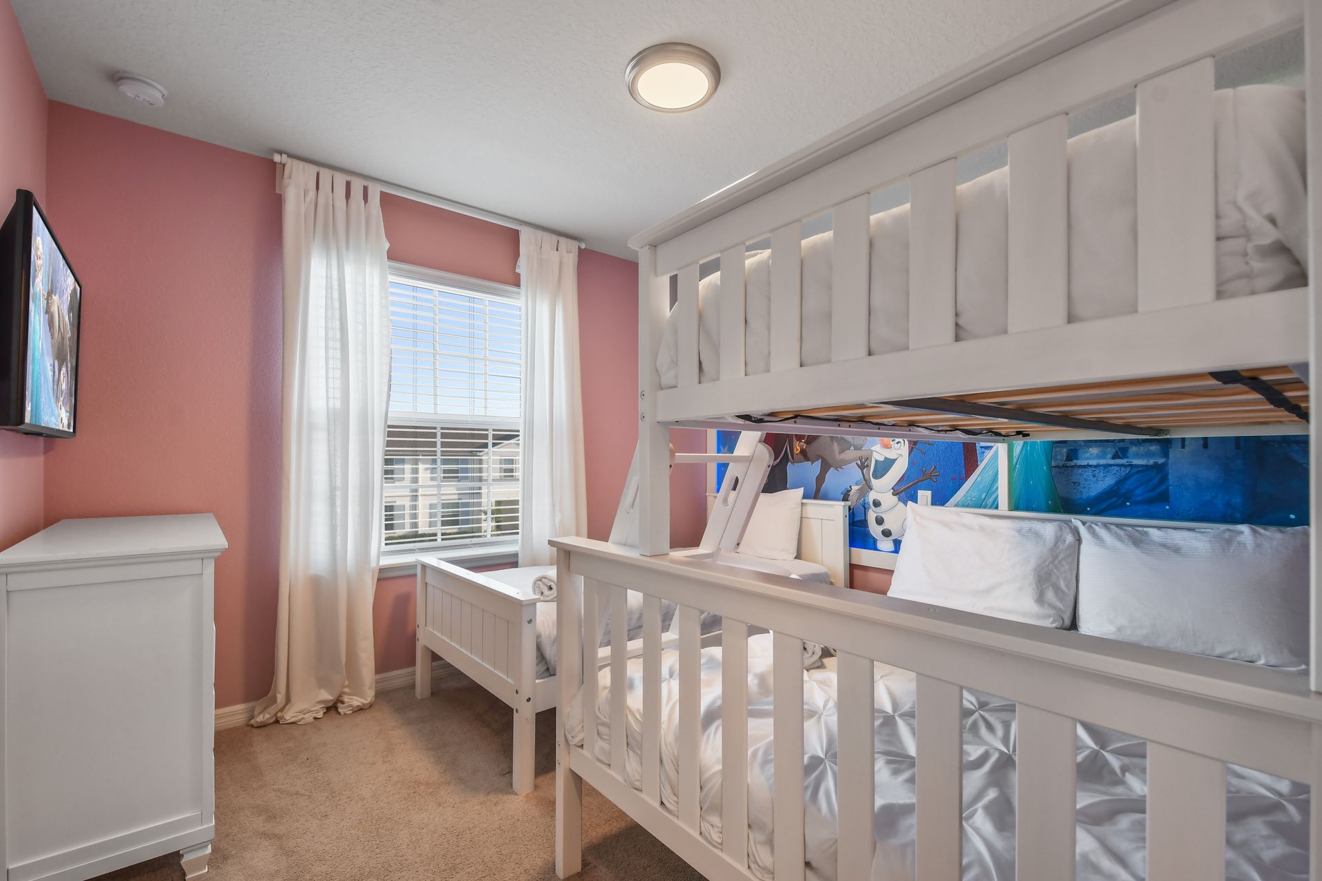 Frozen-themed room with cozy bunk beds, soft lighting, and a magical winter touch.
