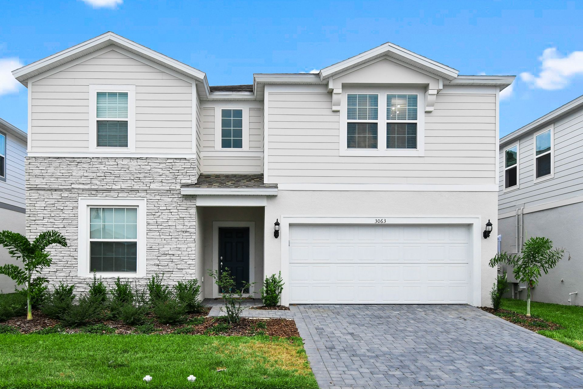 Modern 2-story vacation home with private pool, stylish interiors, and 2-car garage.