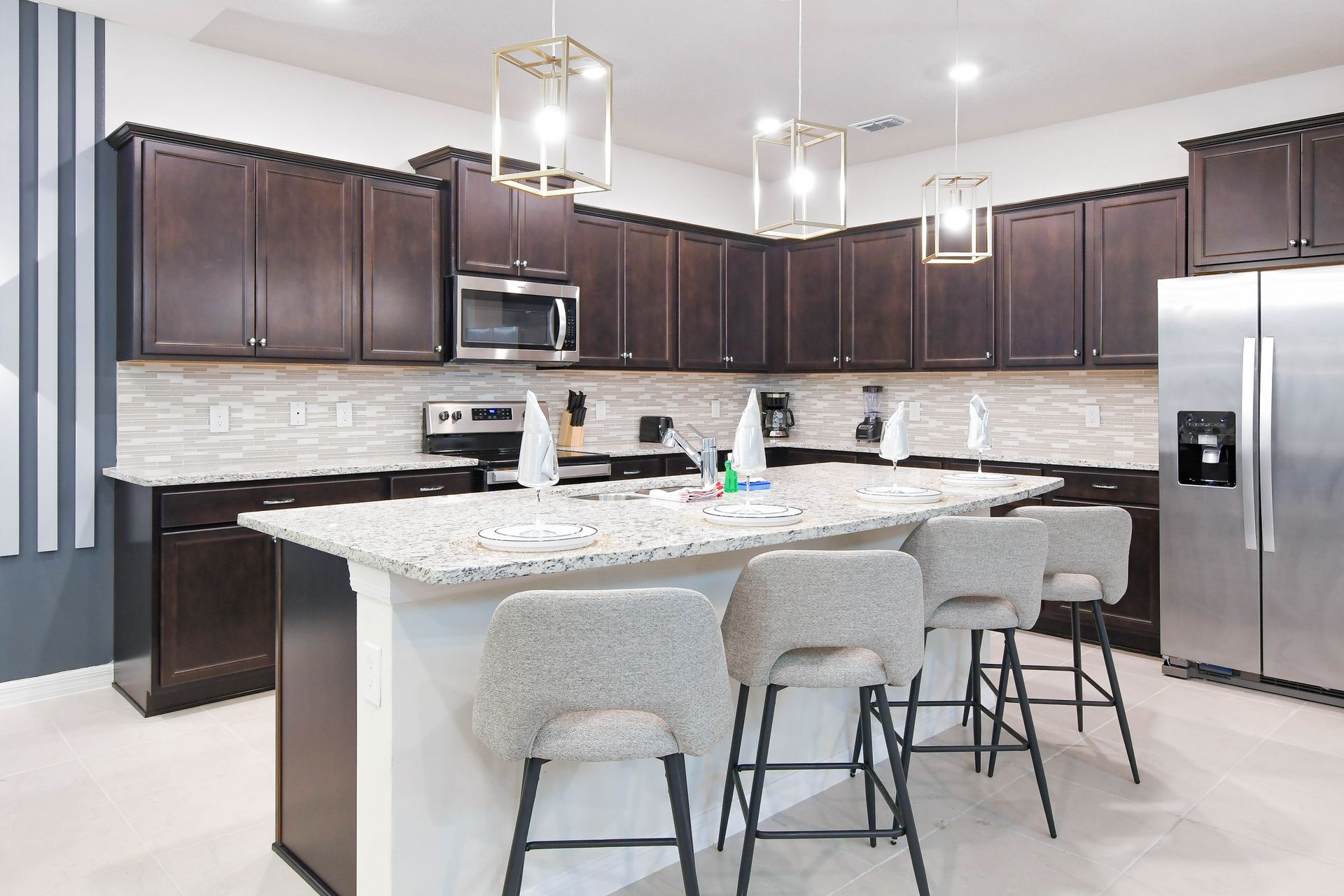 Modern chef’s kitchen with granite countertops, island seating, and sleek finishes.