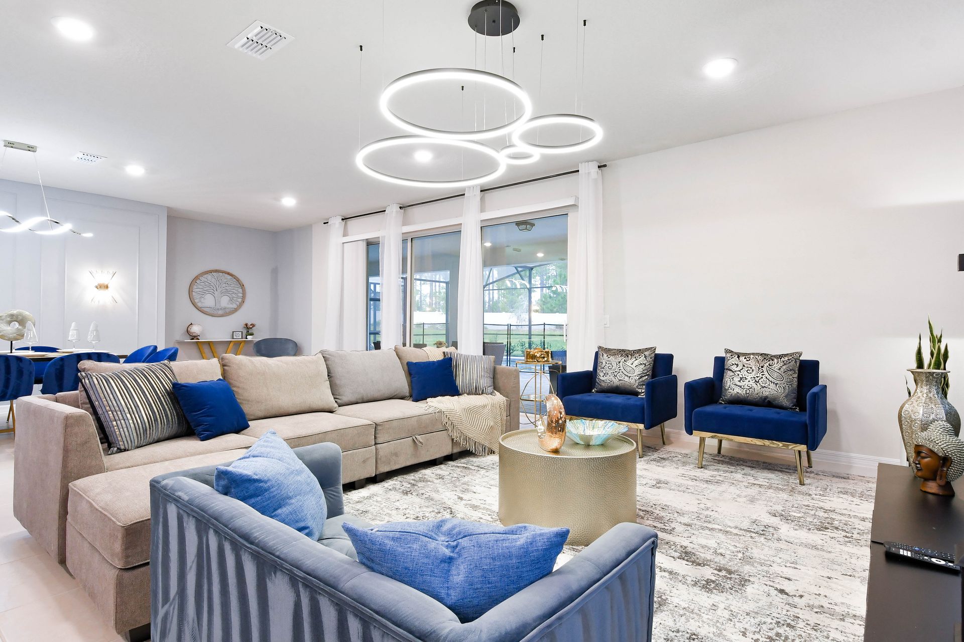 Stylish living room with plush seating, modern lighting, and calming neutral tones.