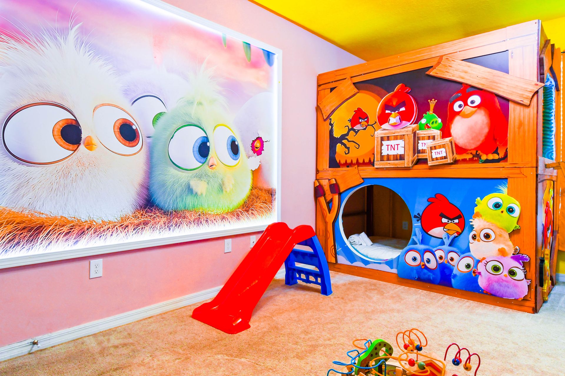 Colorful Angry Birds-themed kids' room with custom bunk beds and playful decor.