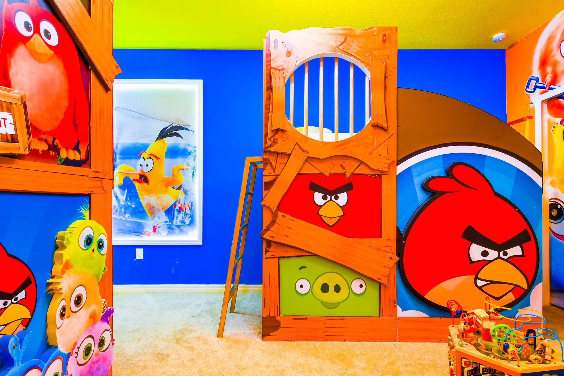 Colorful Angry Birds-themed kids' room with custom bunk beds and playful decor.