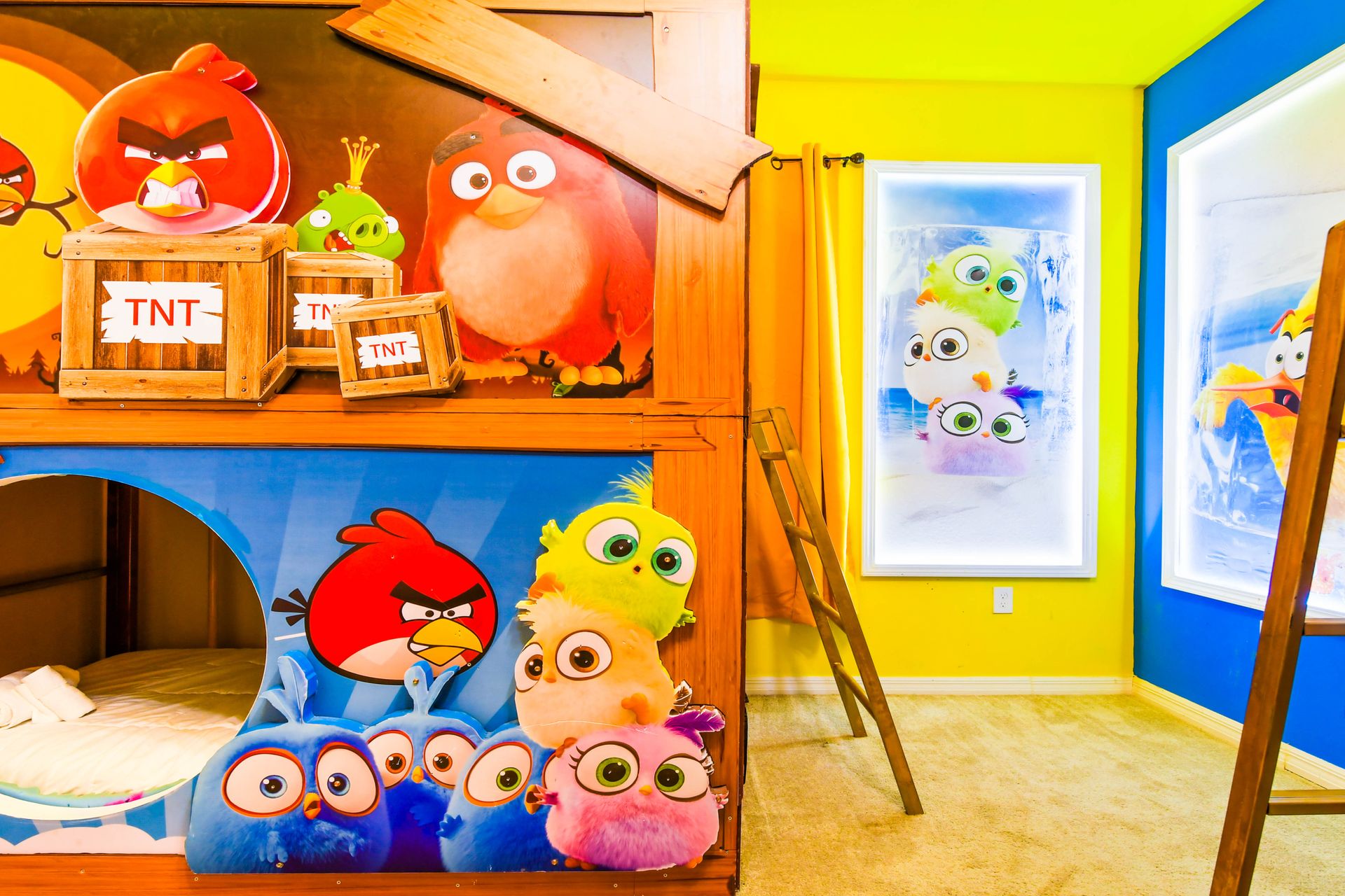 Vibrant Angry Birds-themed room with custom bunk beds, slides, and playful art.